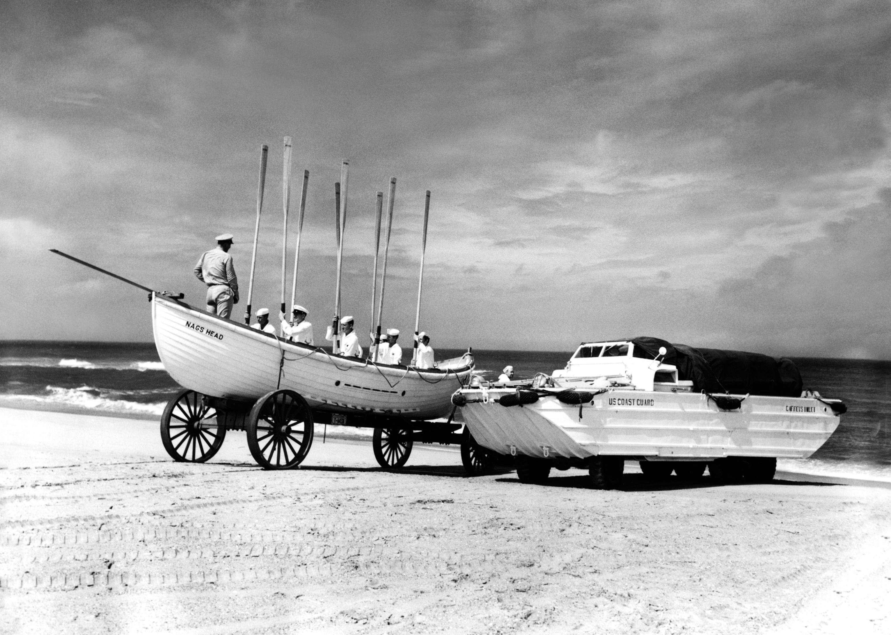 A Coast Guard boat on the beach waiting to take off.