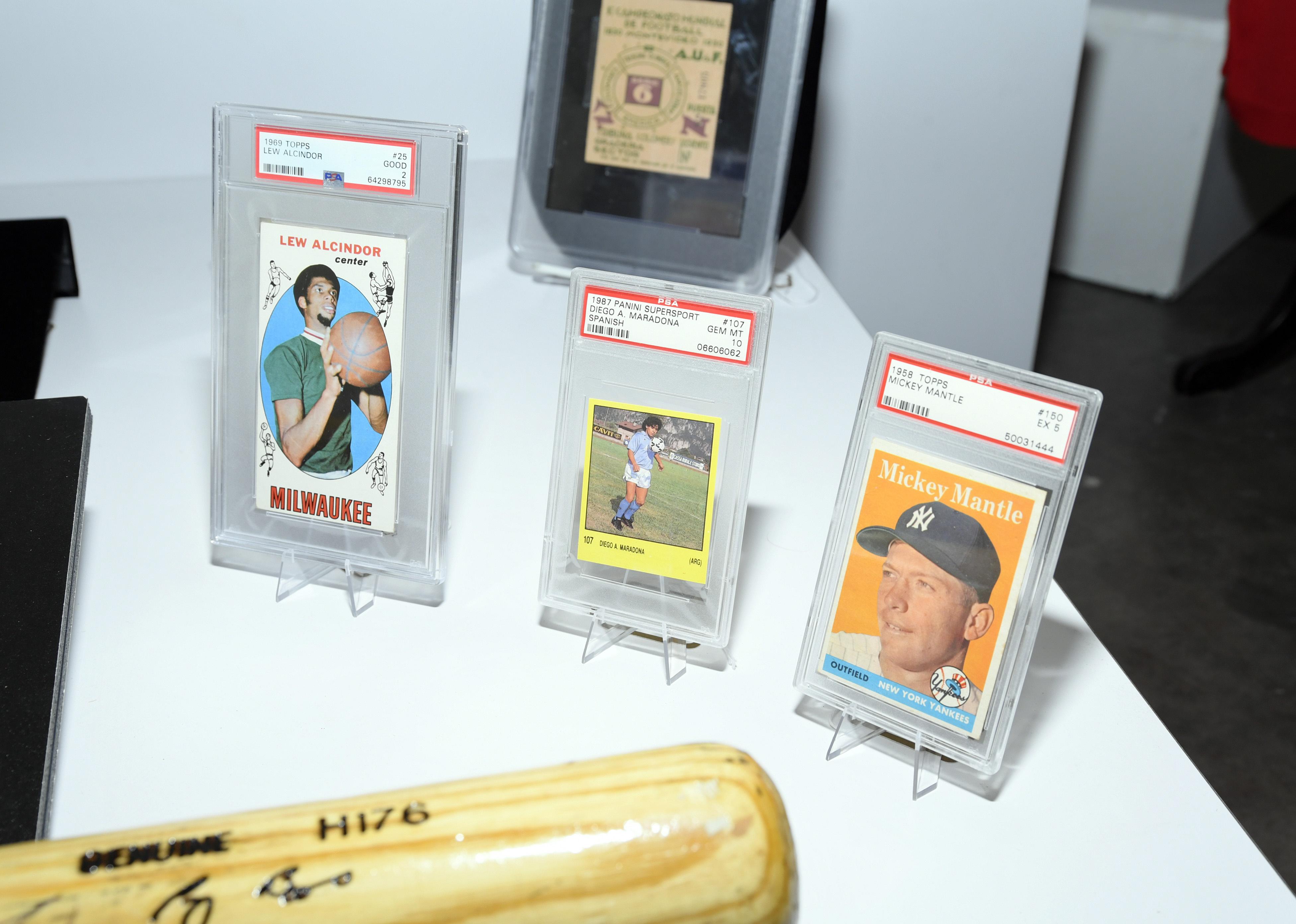 Trading cards of Lew Alcindor (now Kareem Abdul-Jabbar), Diego Maradona and Mickey Mantle are displayed during Julian's Auctions Sports Legends press preview on a table.