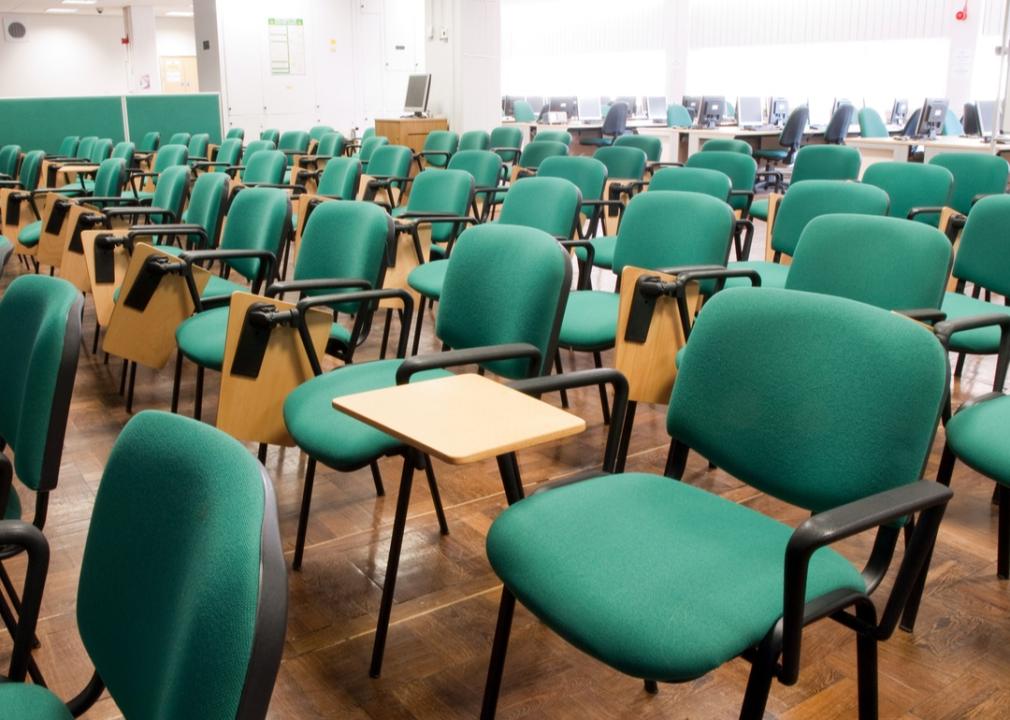 Empty green chairs in a lecture room.