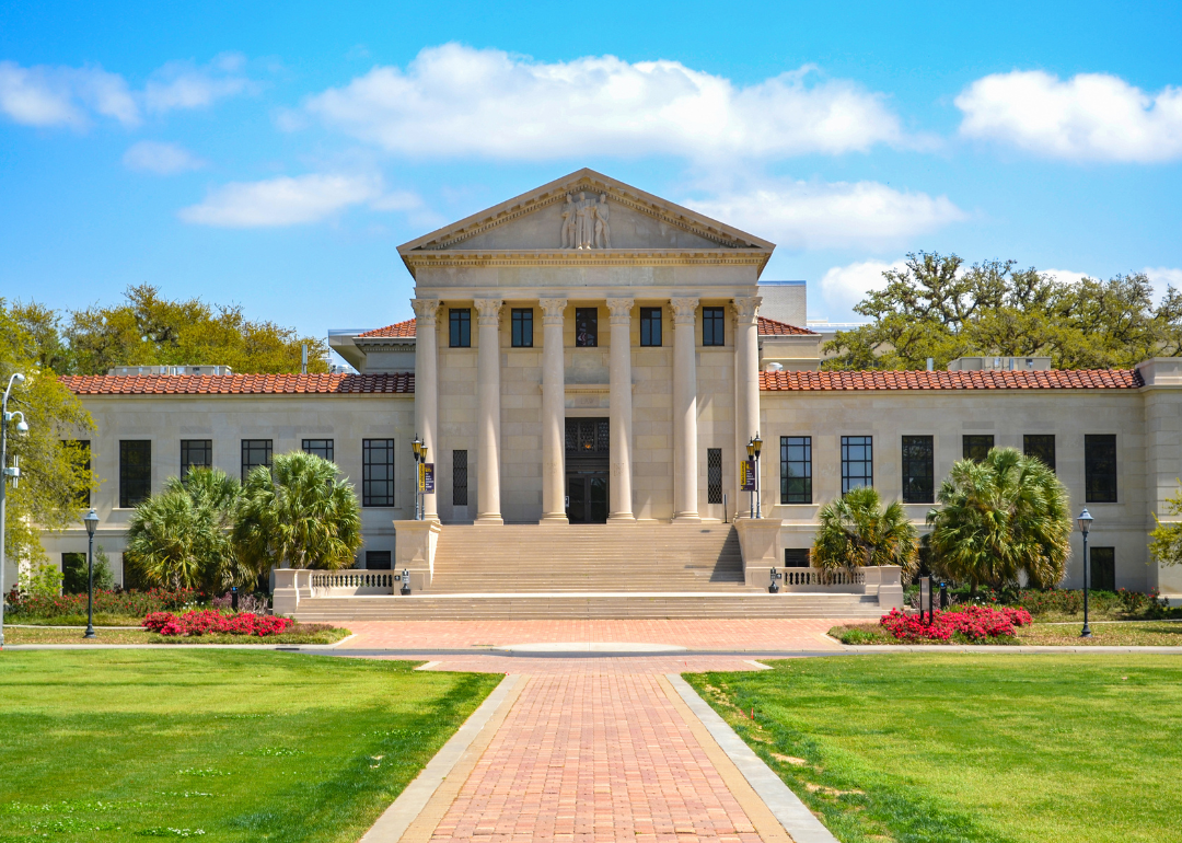 A historic stone university building with columns in front in Baton Rouge.