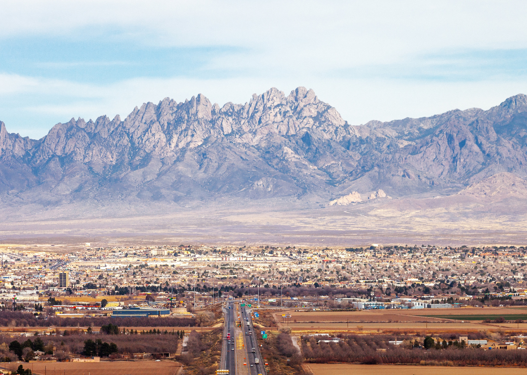 Aerial view of the sprawling city of Las Cruces at the base of the mountains.