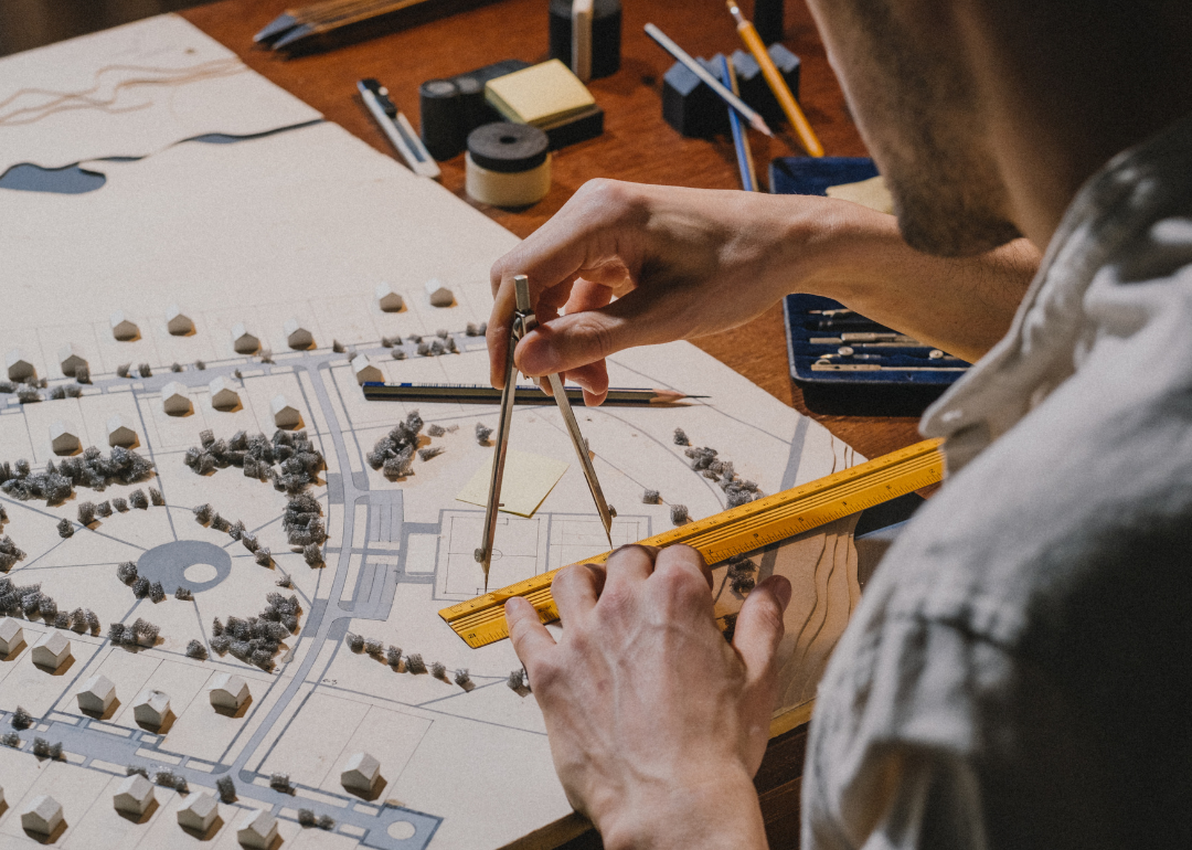 A man working with an architectural model.