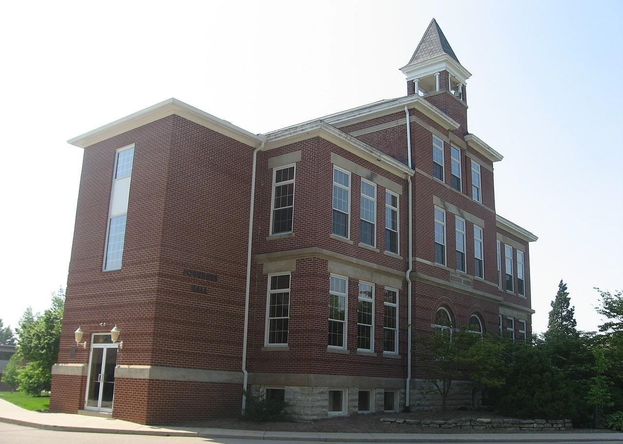 A red brick building with large windows.