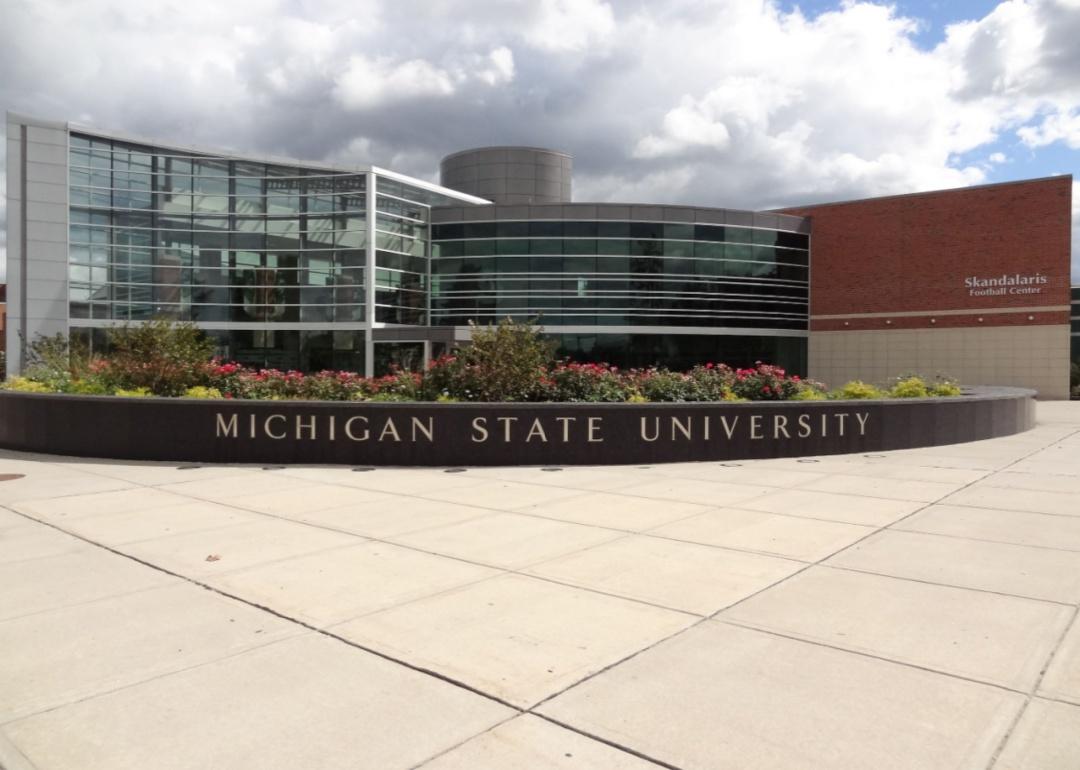 A round glass building with a Michigan State University sign in front.