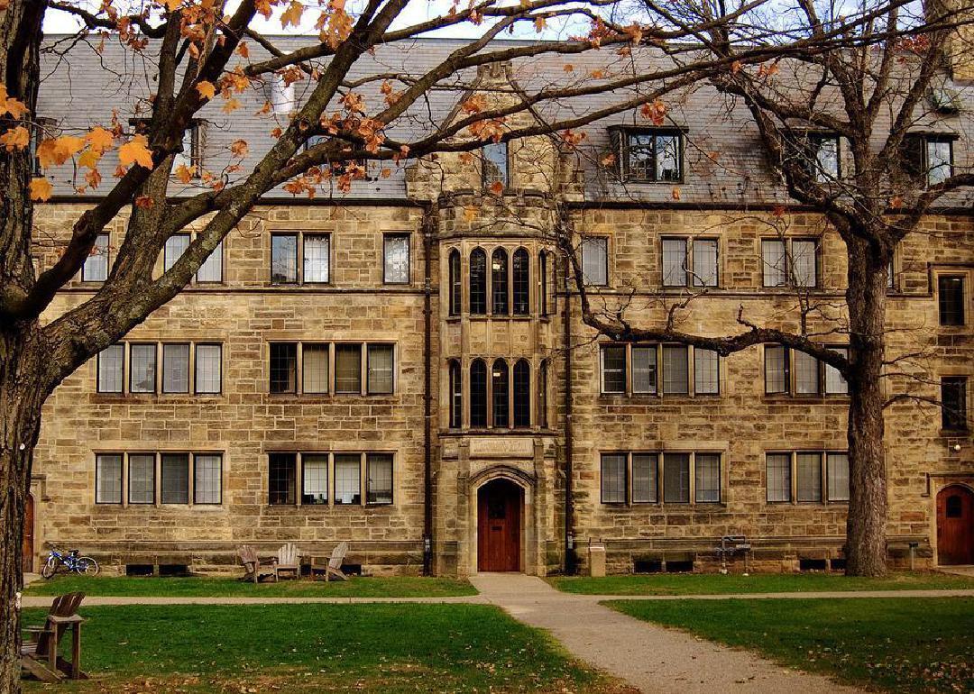 A long four story stone building with windows.