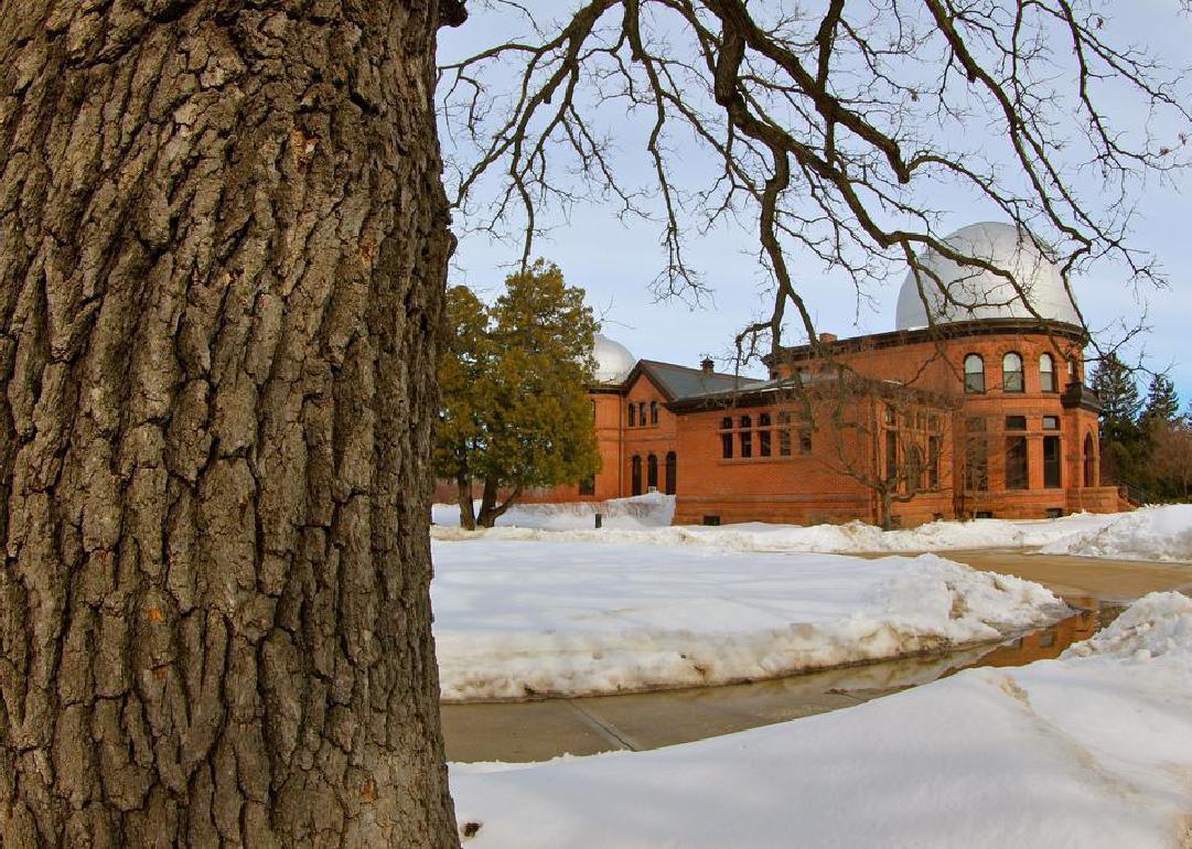 A brick building with a silver dome on top.