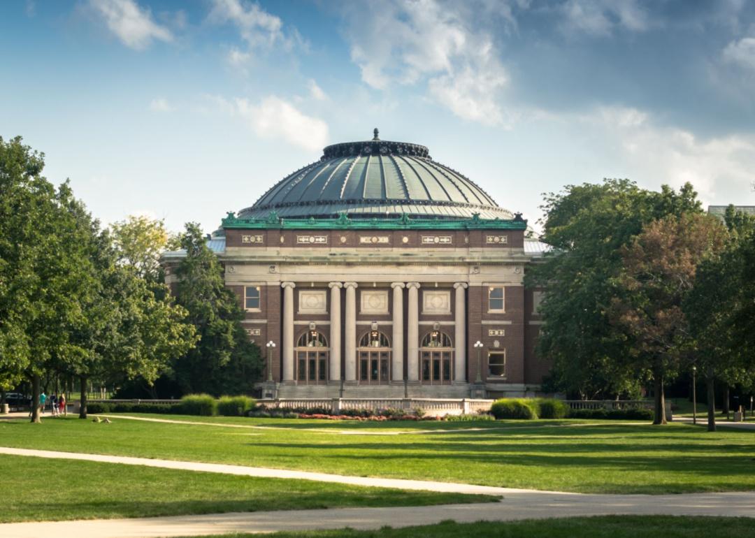 A brick building with a large green dome on top.