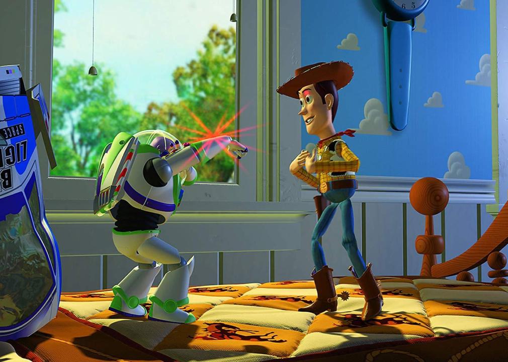 A cartoon of Woody the cowboy looking at Buzz Lightyear the astronaut, as he flashes a red light.