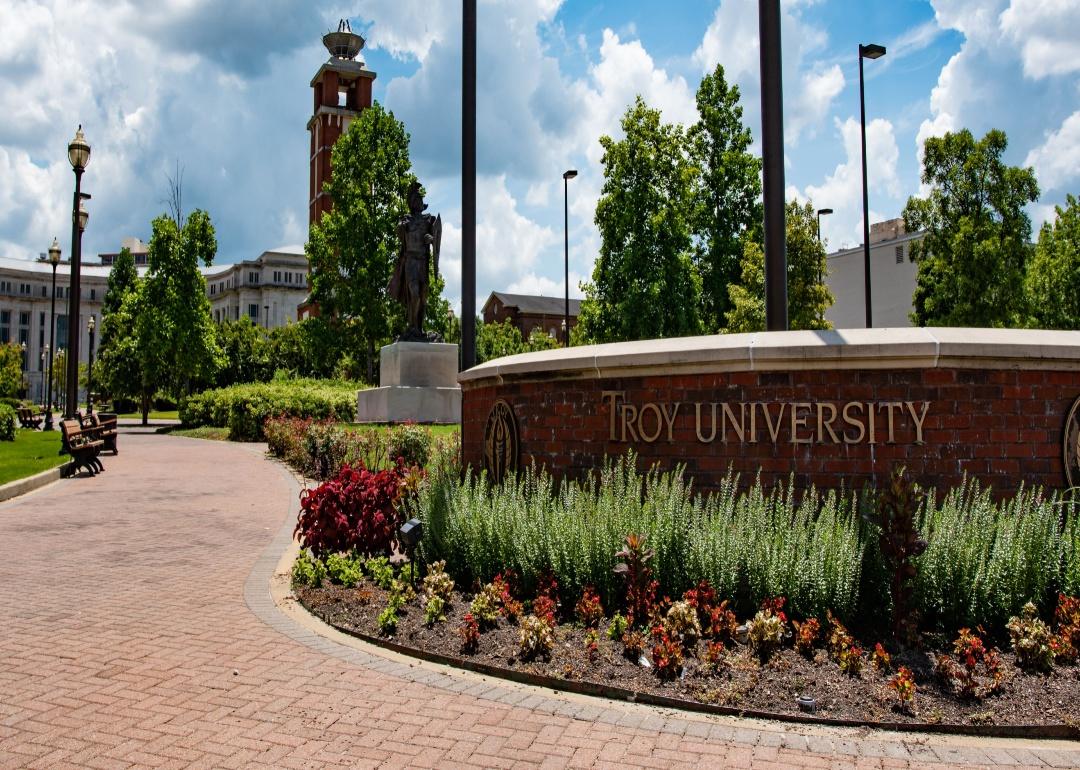 A brick entrance to Troy University.