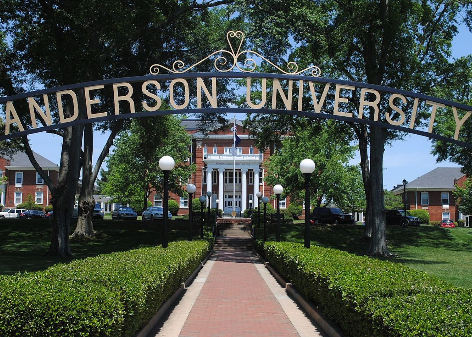 An arched iron sign to Anderson University.