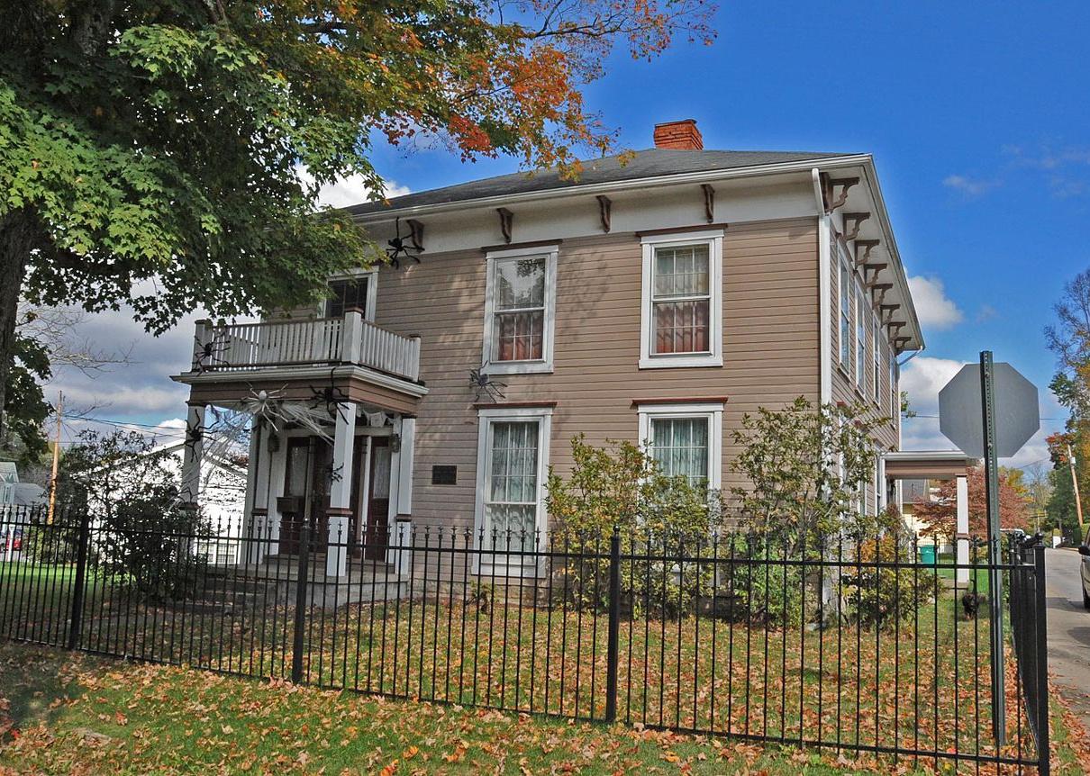 A brown two-story historic home.