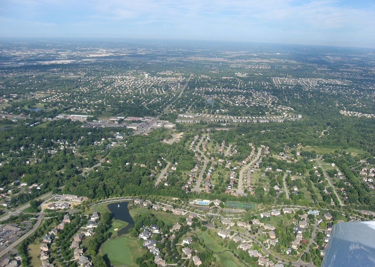 An aerial view of homes and a golf course.