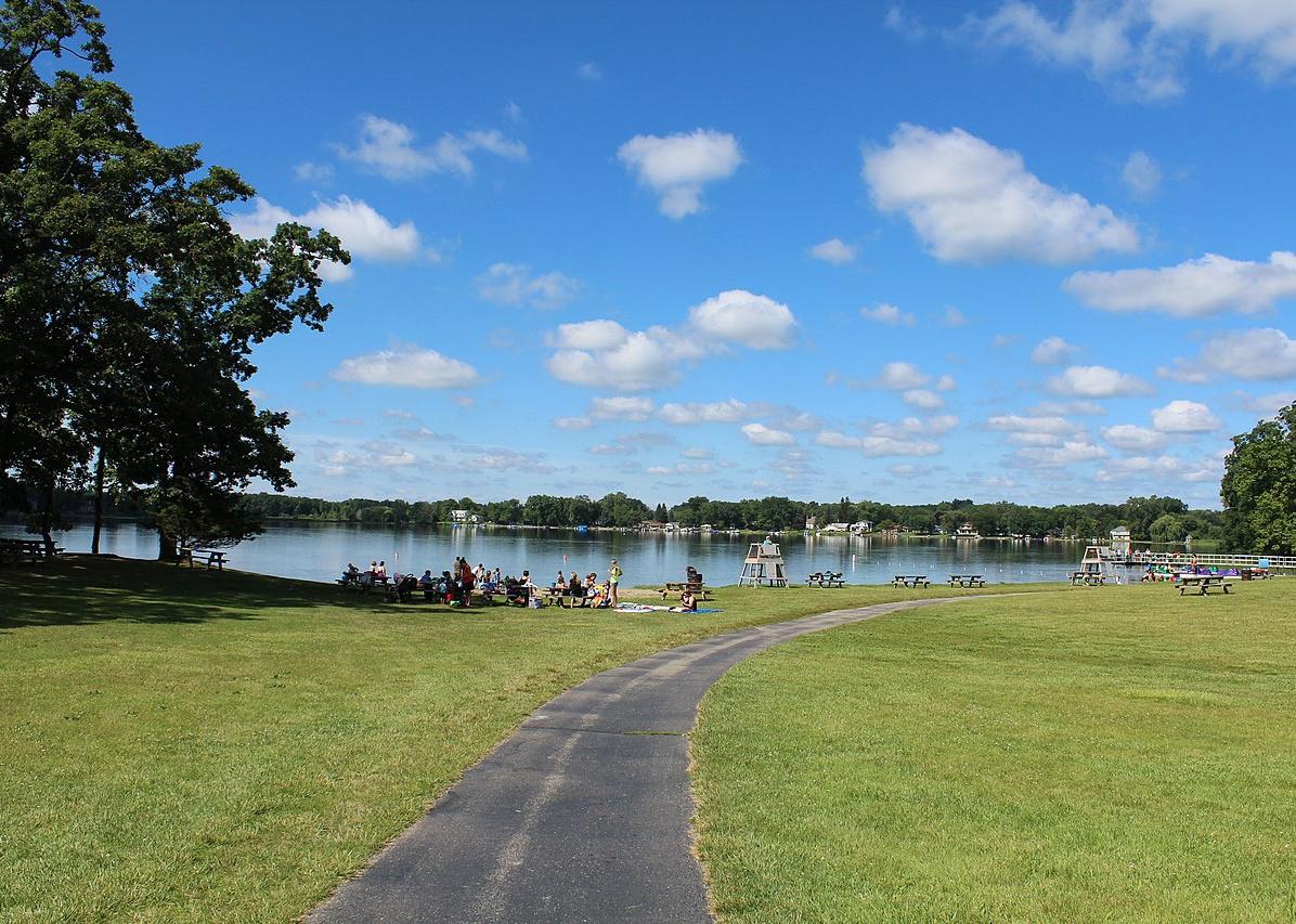 People gathered in the summer at a lake park.