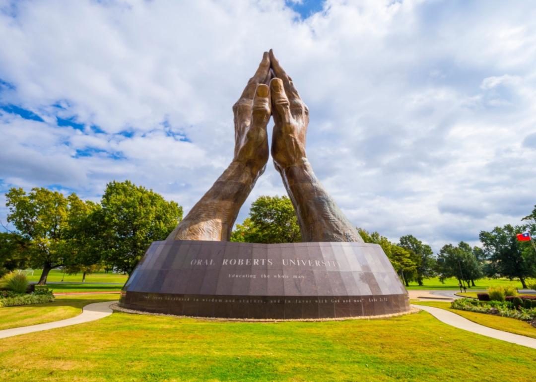 A large sculpture of praying hands at Oral Roberts University.