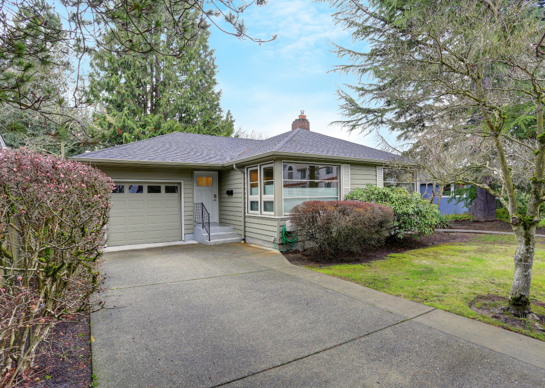 Small grey home with one car garage.