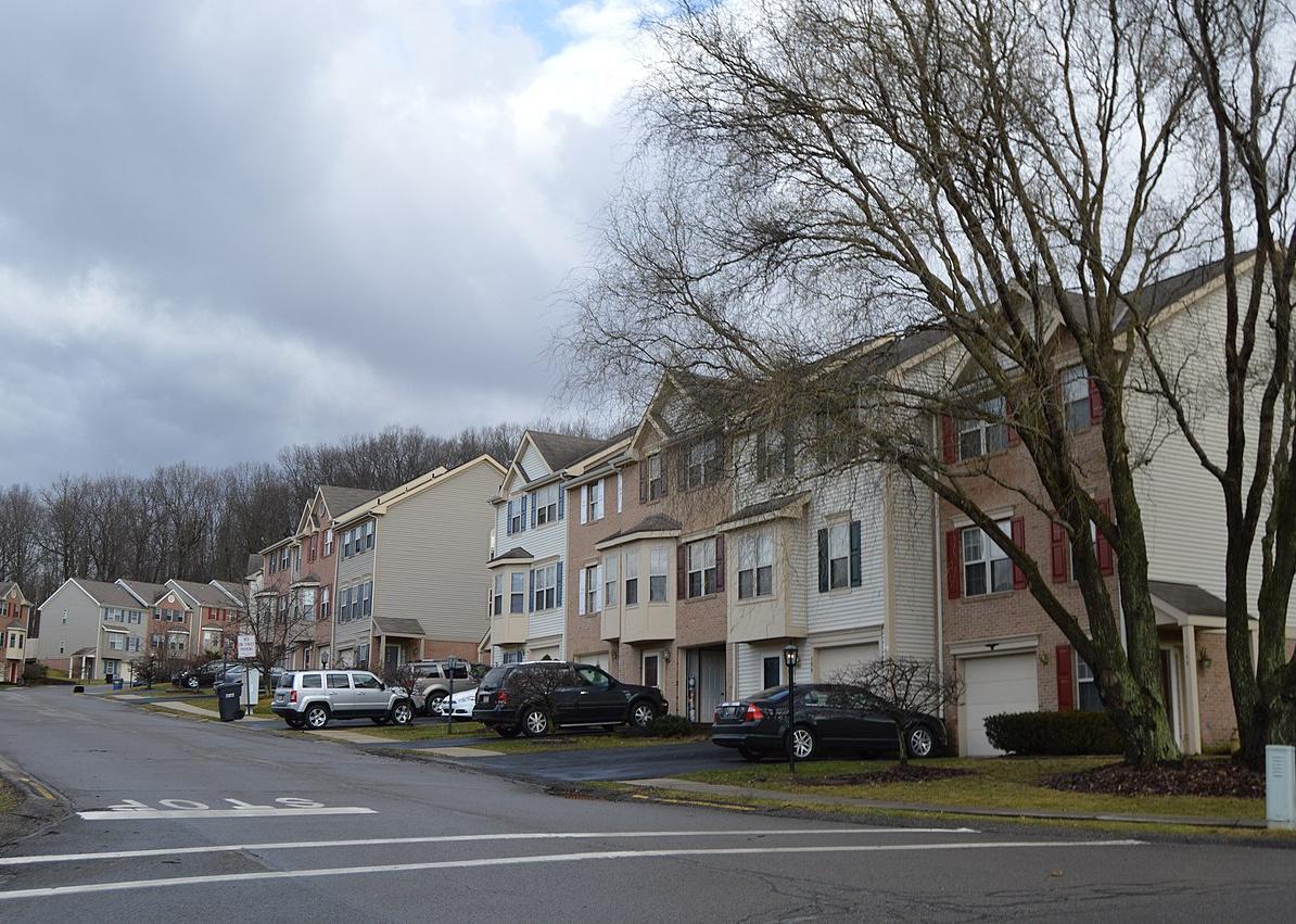 A winding street of row homes.