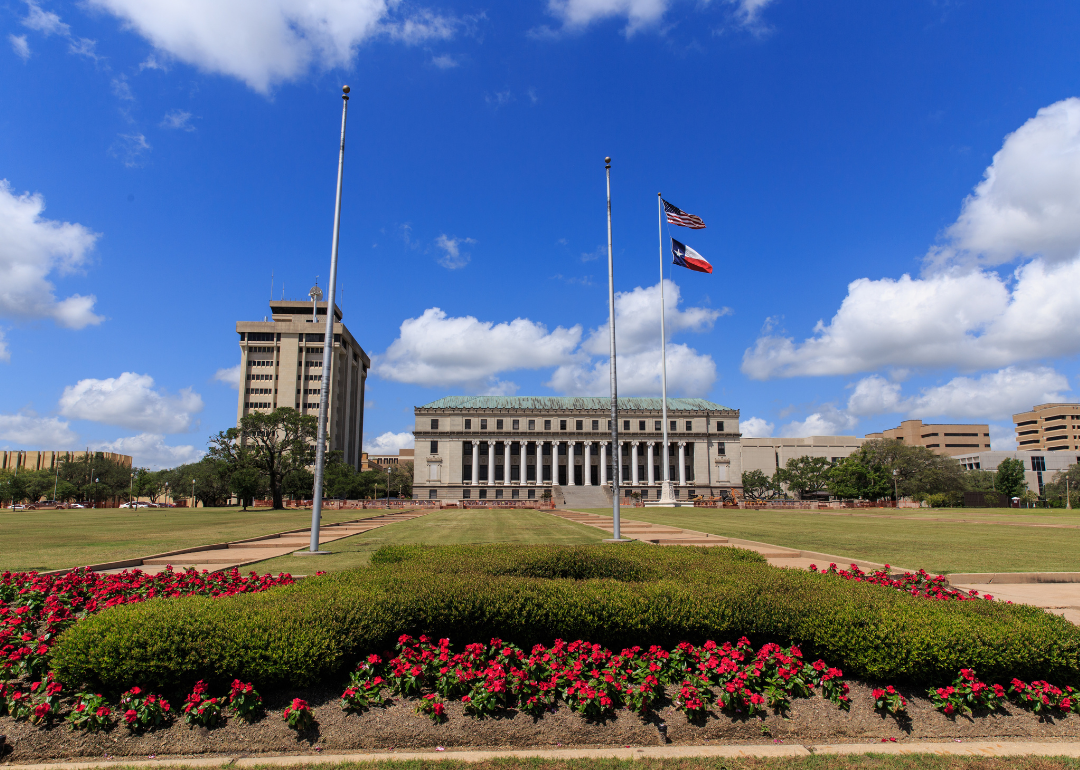 Texas A&M University with flags and floral landscaping.