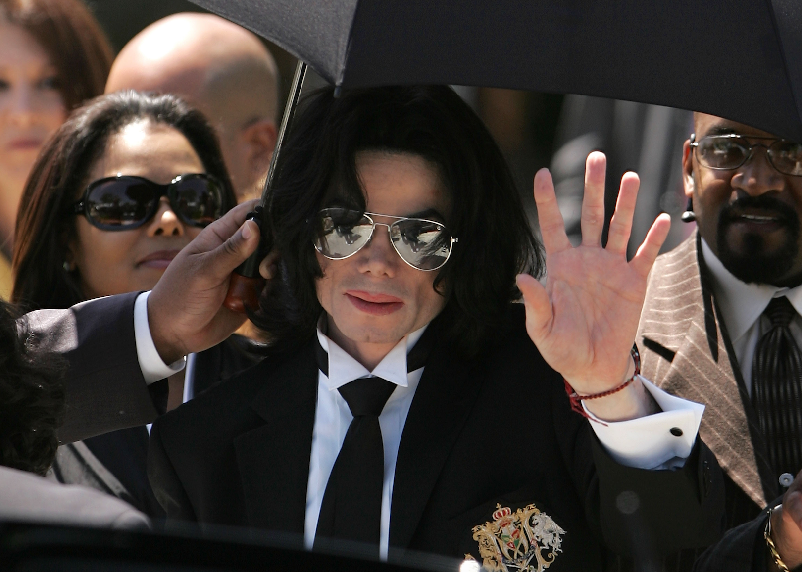 Michael Jackson in a black suit and sunglasses.