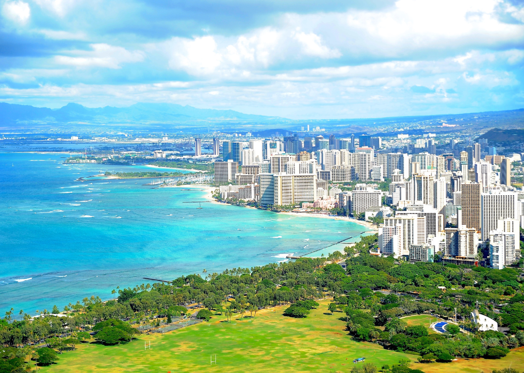 Turquoise water and beach along the downtown coastline of Honolulu.