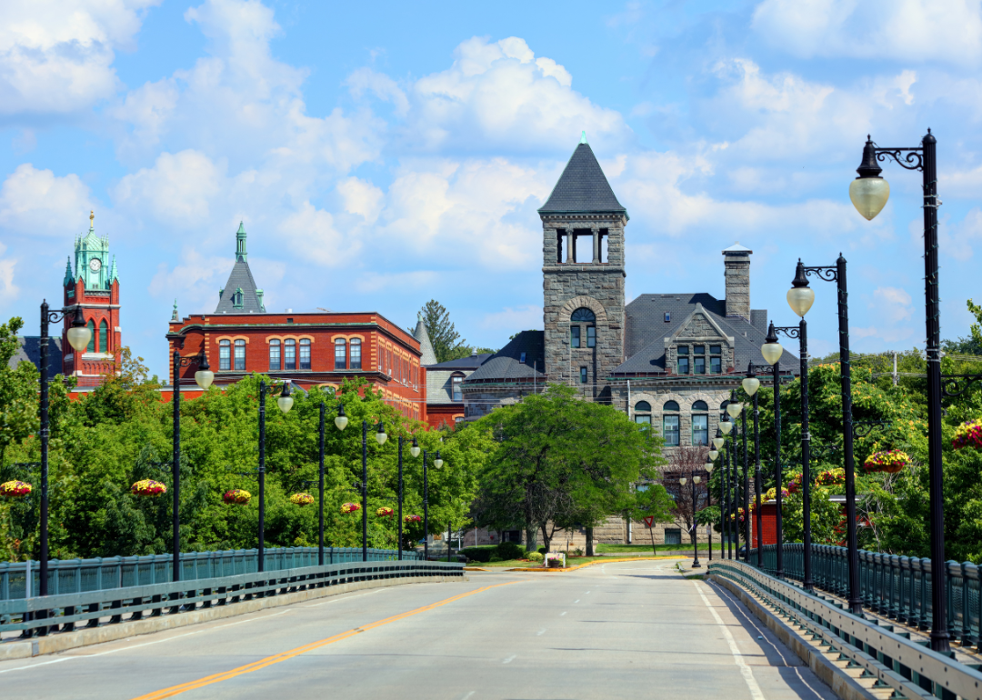 A bridge heading into Woonsocket with historic brick buildings.