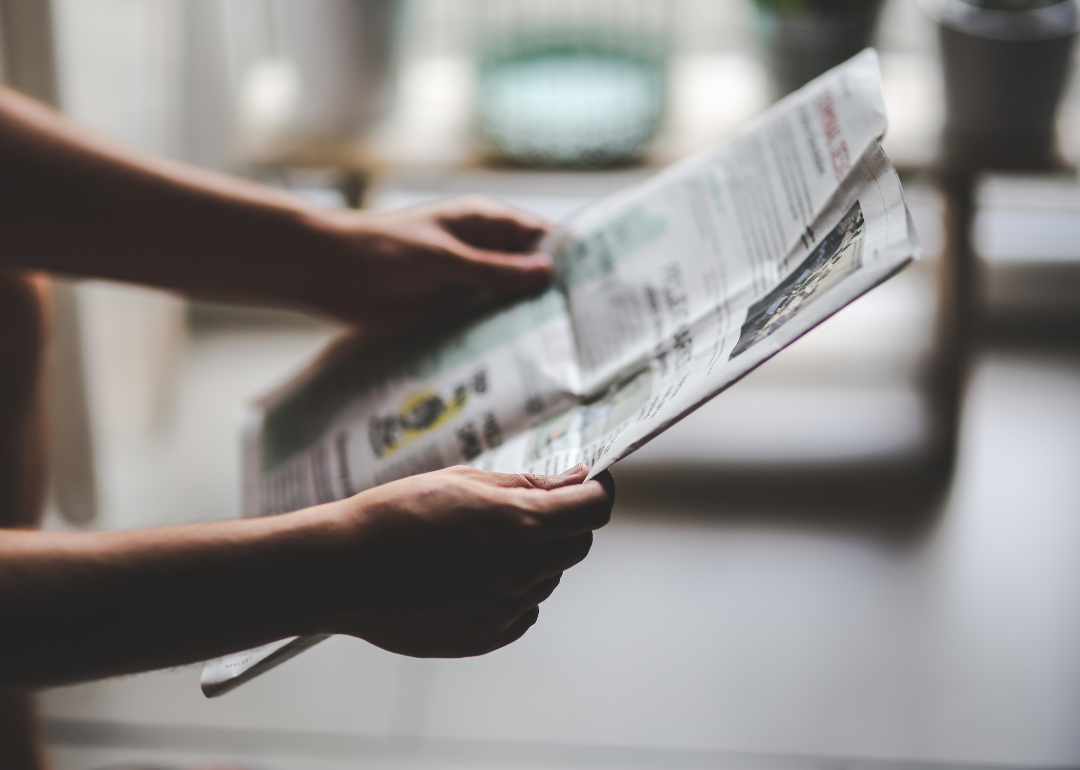 A person holding a newspaper.