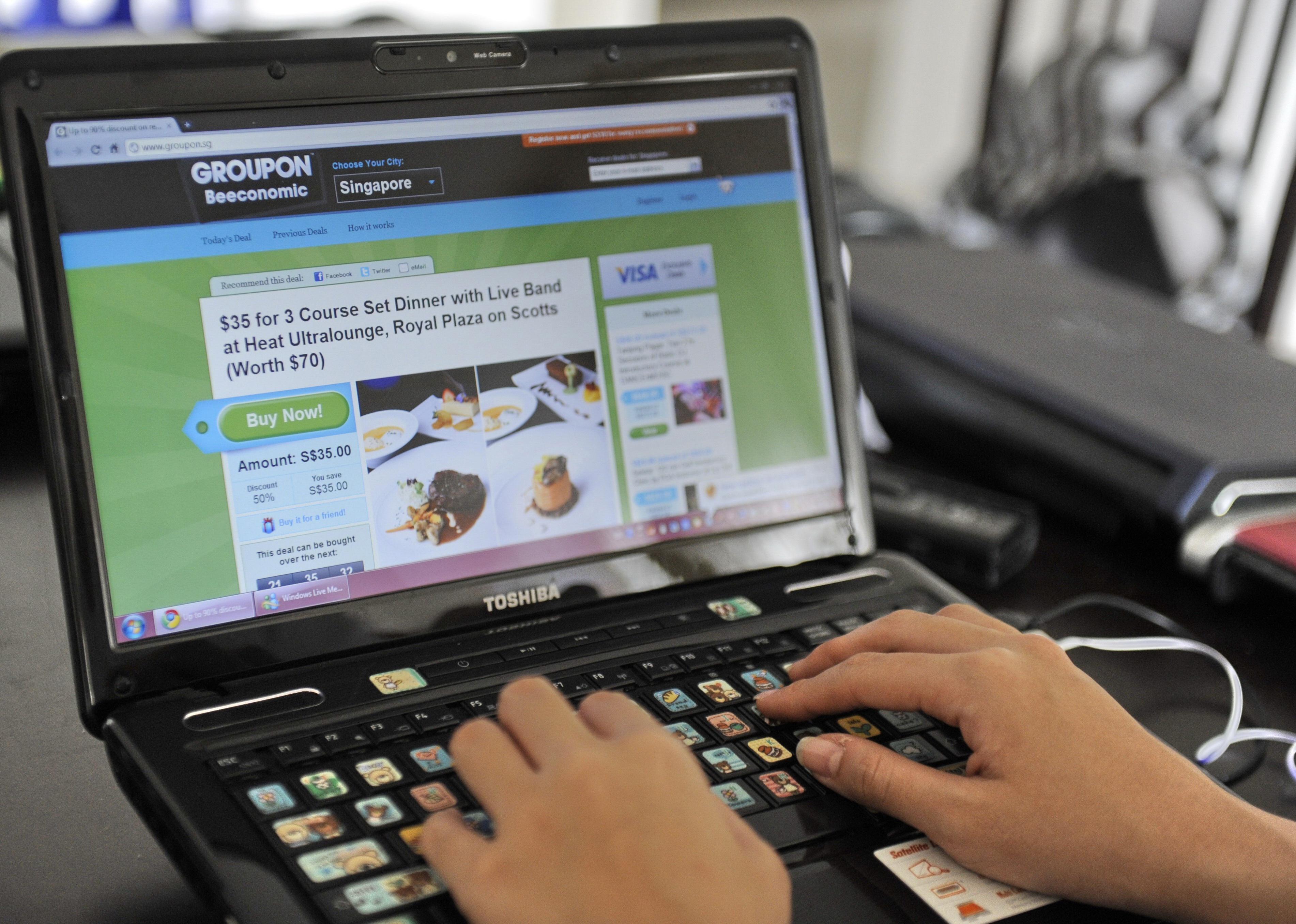 A person looking at a digital coupon on a laptop.