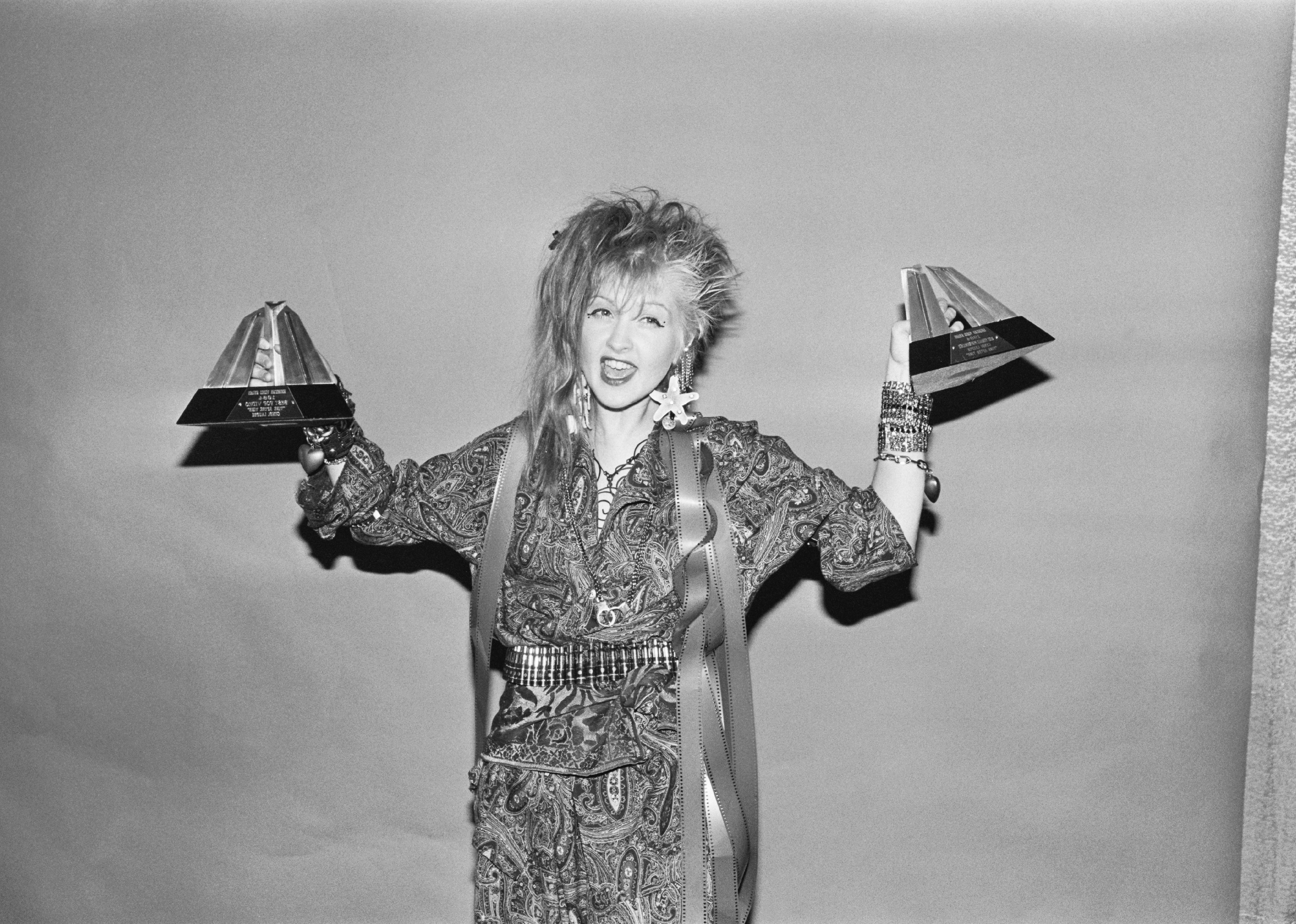 Cyndi Lauper holding an award.