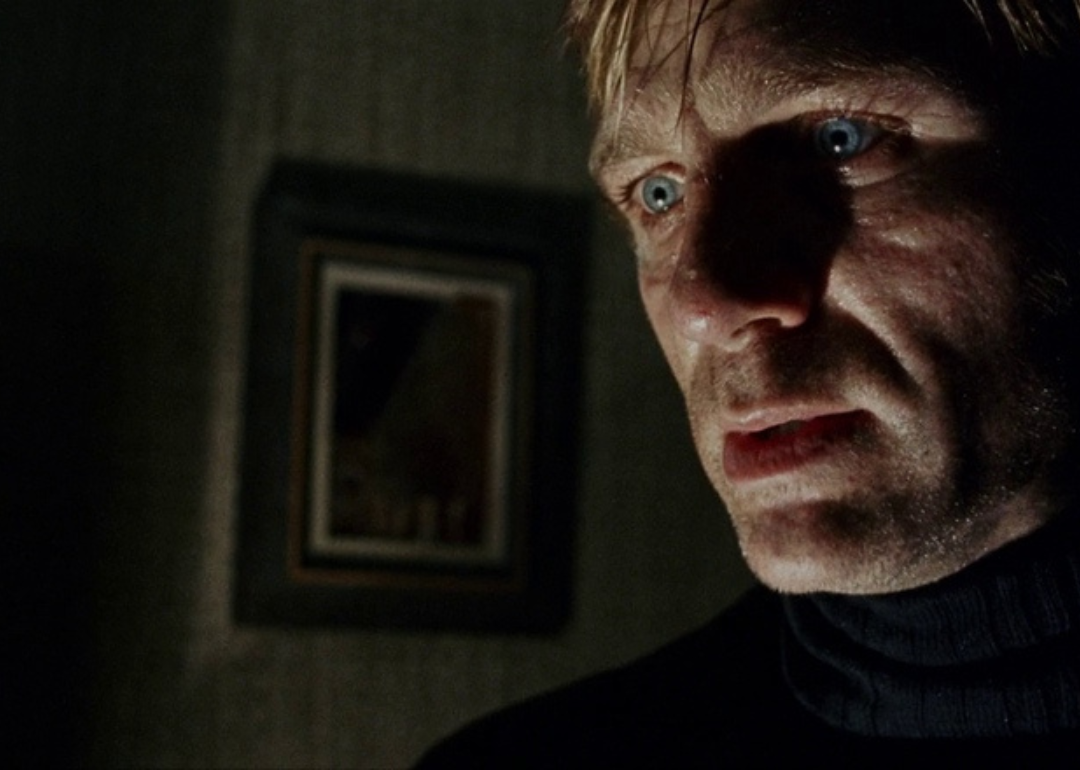 Daniel Craig in black with an intense stare.