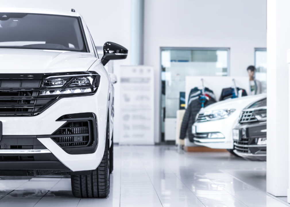 Vehicles on display in dealership showroom.