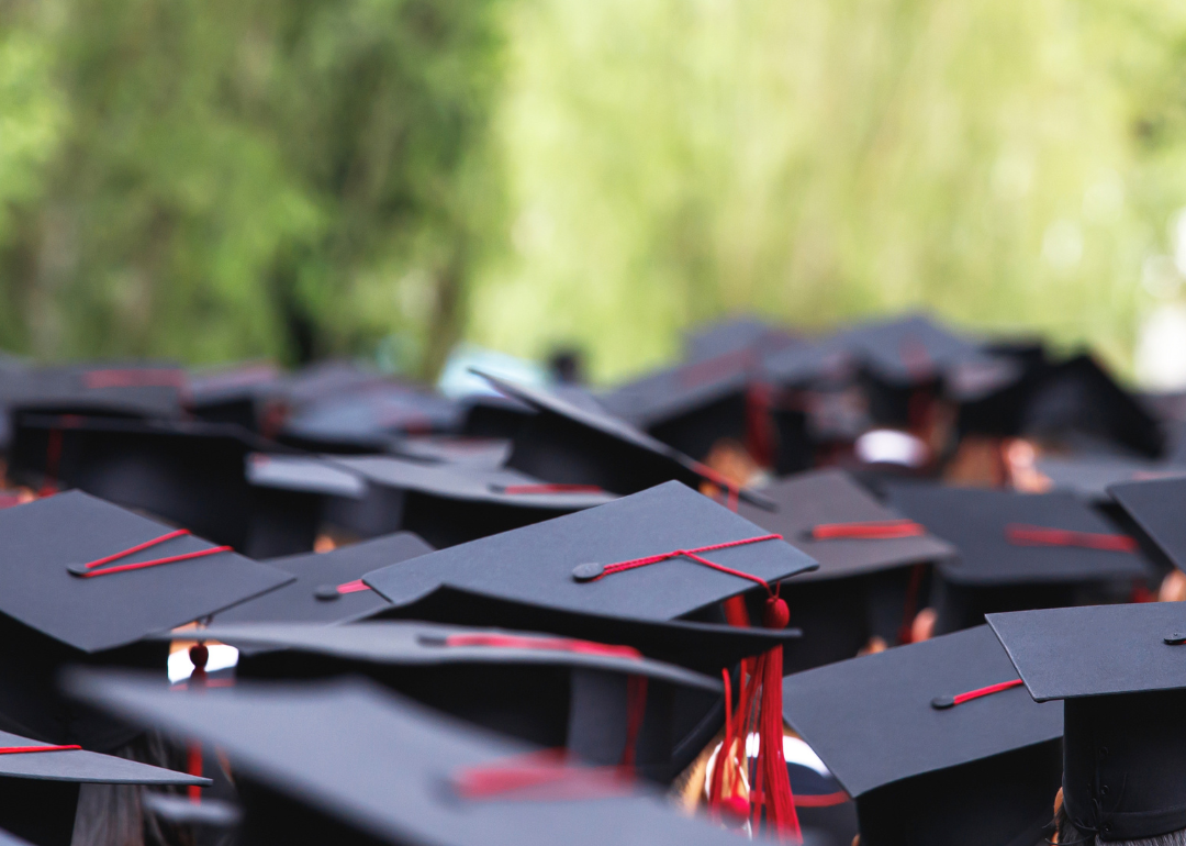 Students graduating in black caps and gowns.