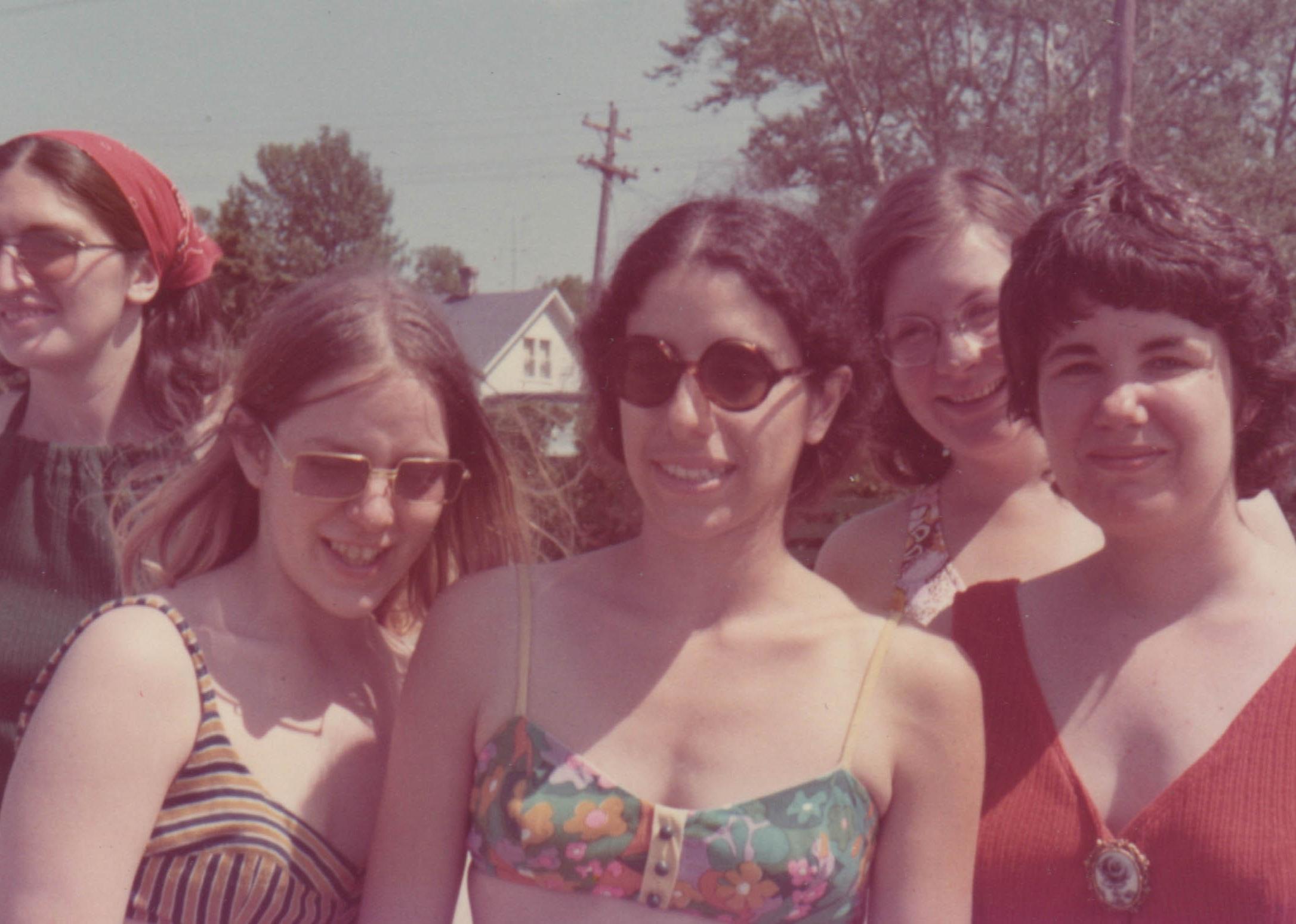 A group of smiling women in 1970s era summer clothes.