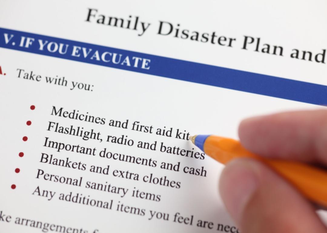 A person looking at a family disaster plan check list.