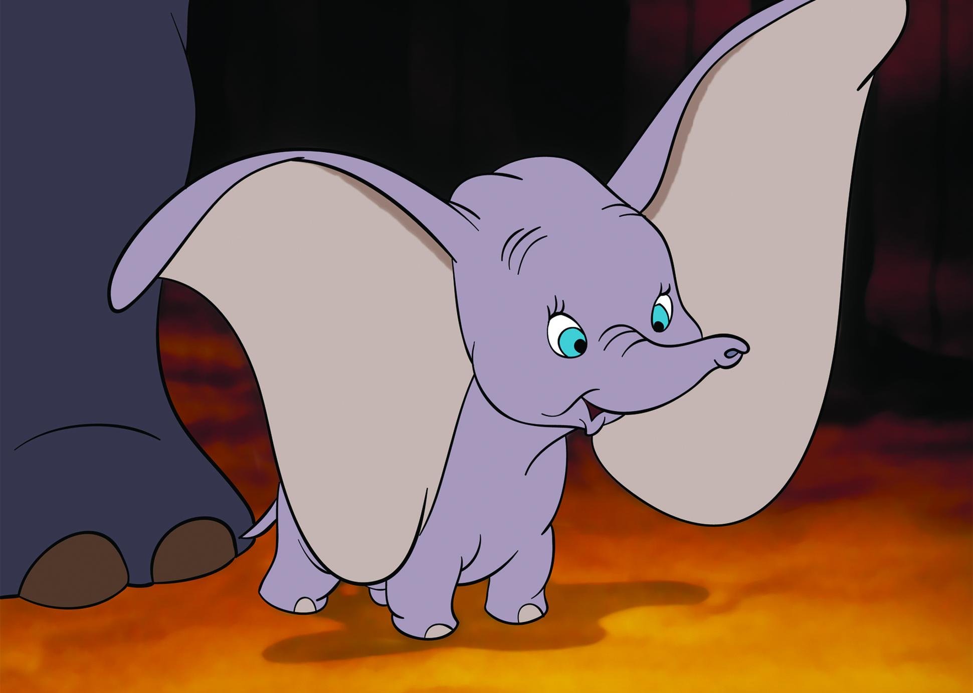 A cartoon of a smiling baby elephant, Dumbo, with huge ears.