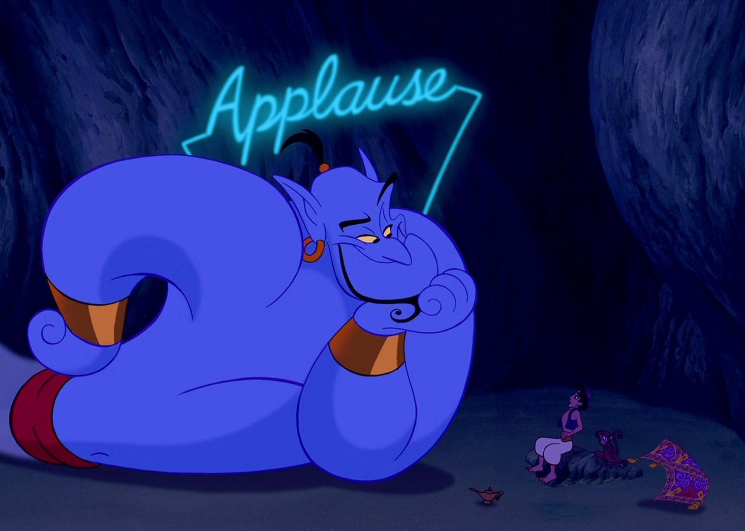 A cartoon blue genie on the floor with an applause sign above his head performing for a man, a monkey and a flying carpet.