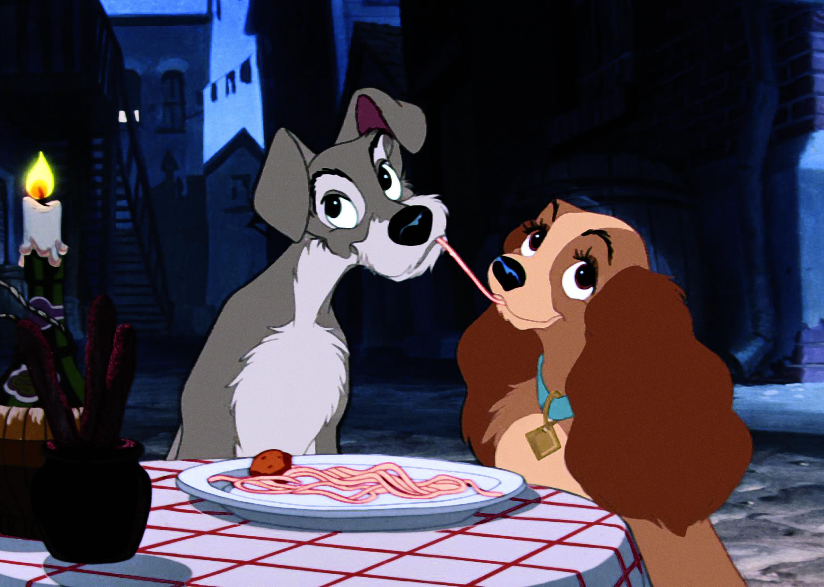 A cartoon of Lady and the Tramp sharing a plate of pasta at a candlelit dinner.