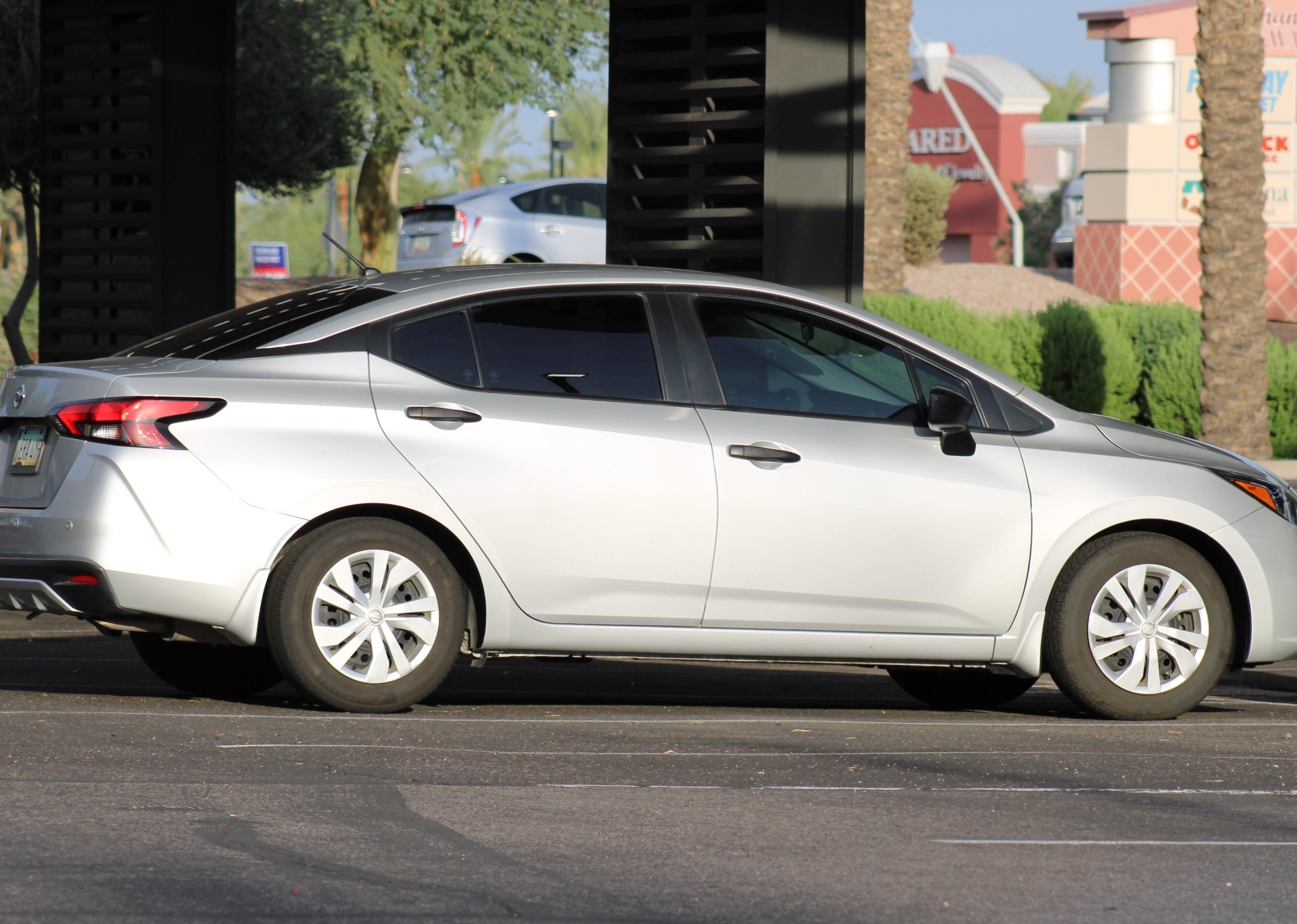 A silver Nissan Versa.