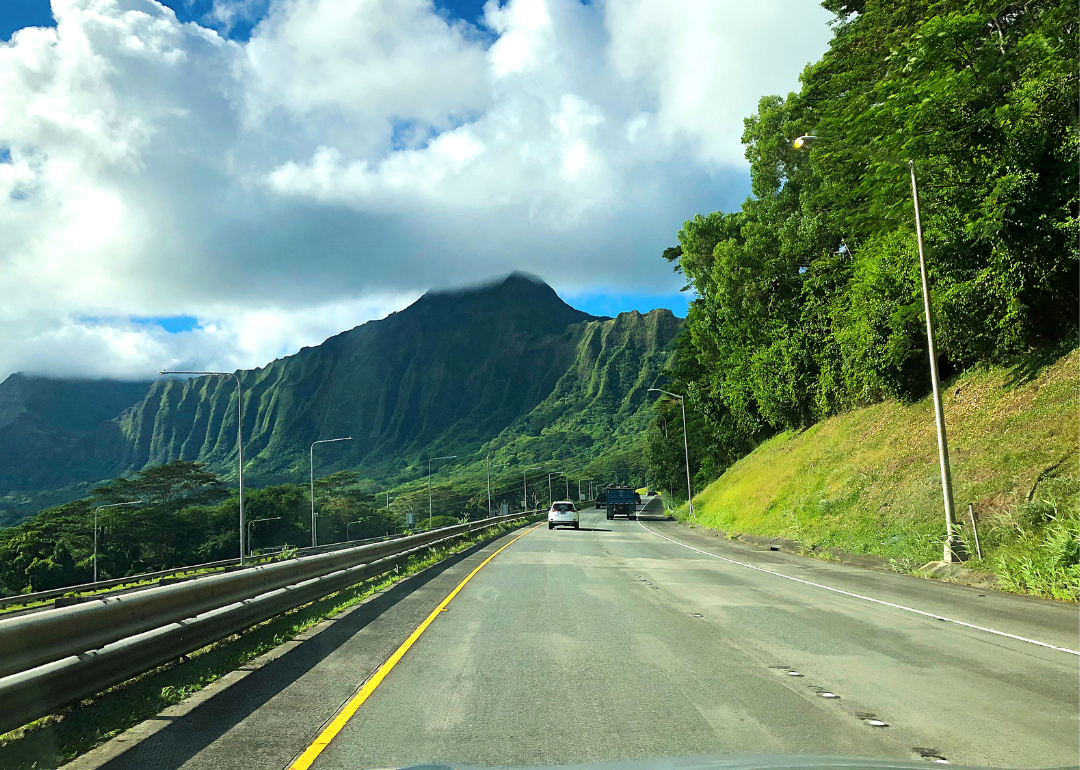 A highway going through green mountains.