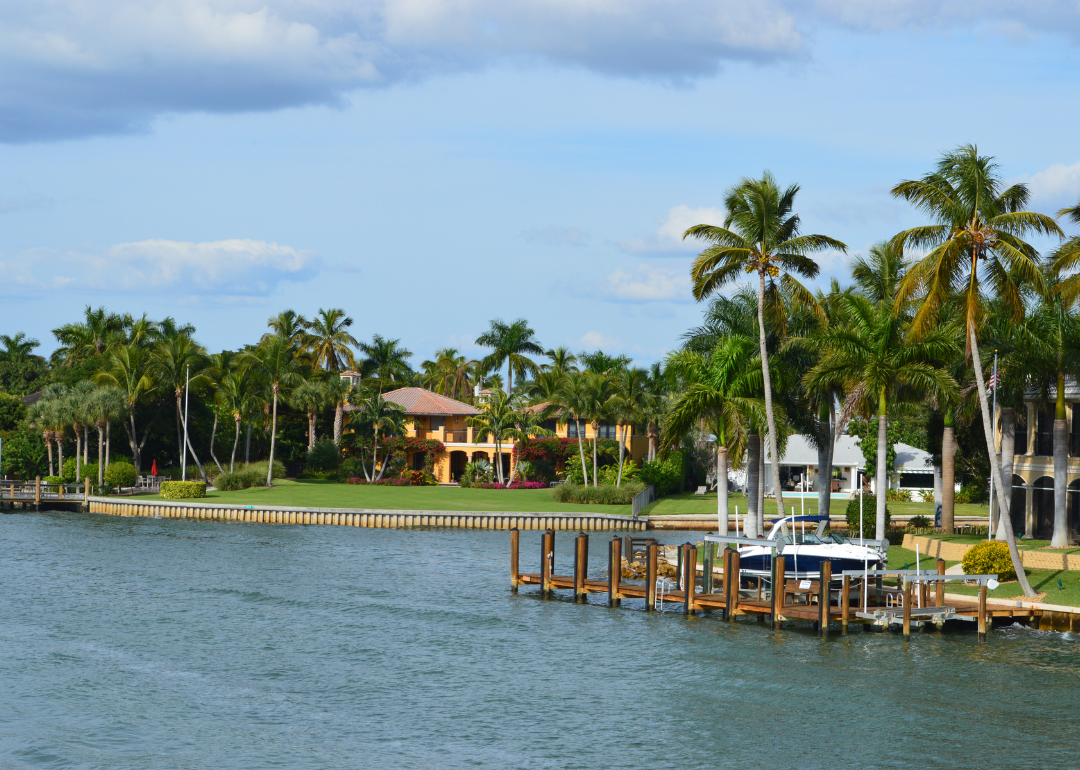 Beautiful homes and a boat and pier on Naples Bay.