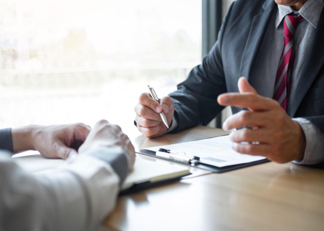 Two people at a desk in an interview.