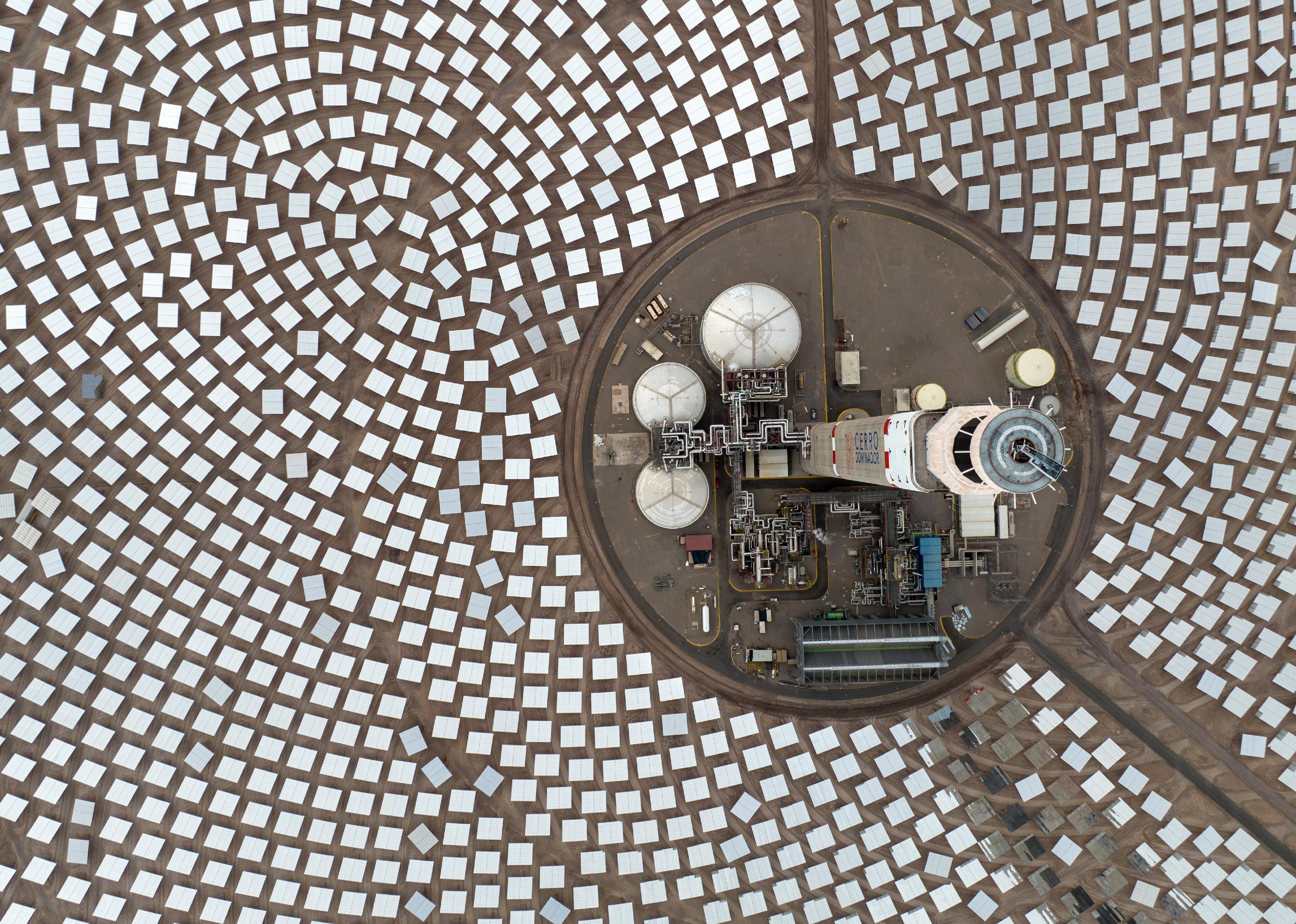 An aerial view of a tower and concentrated solar power plant using mirrors in Chile.