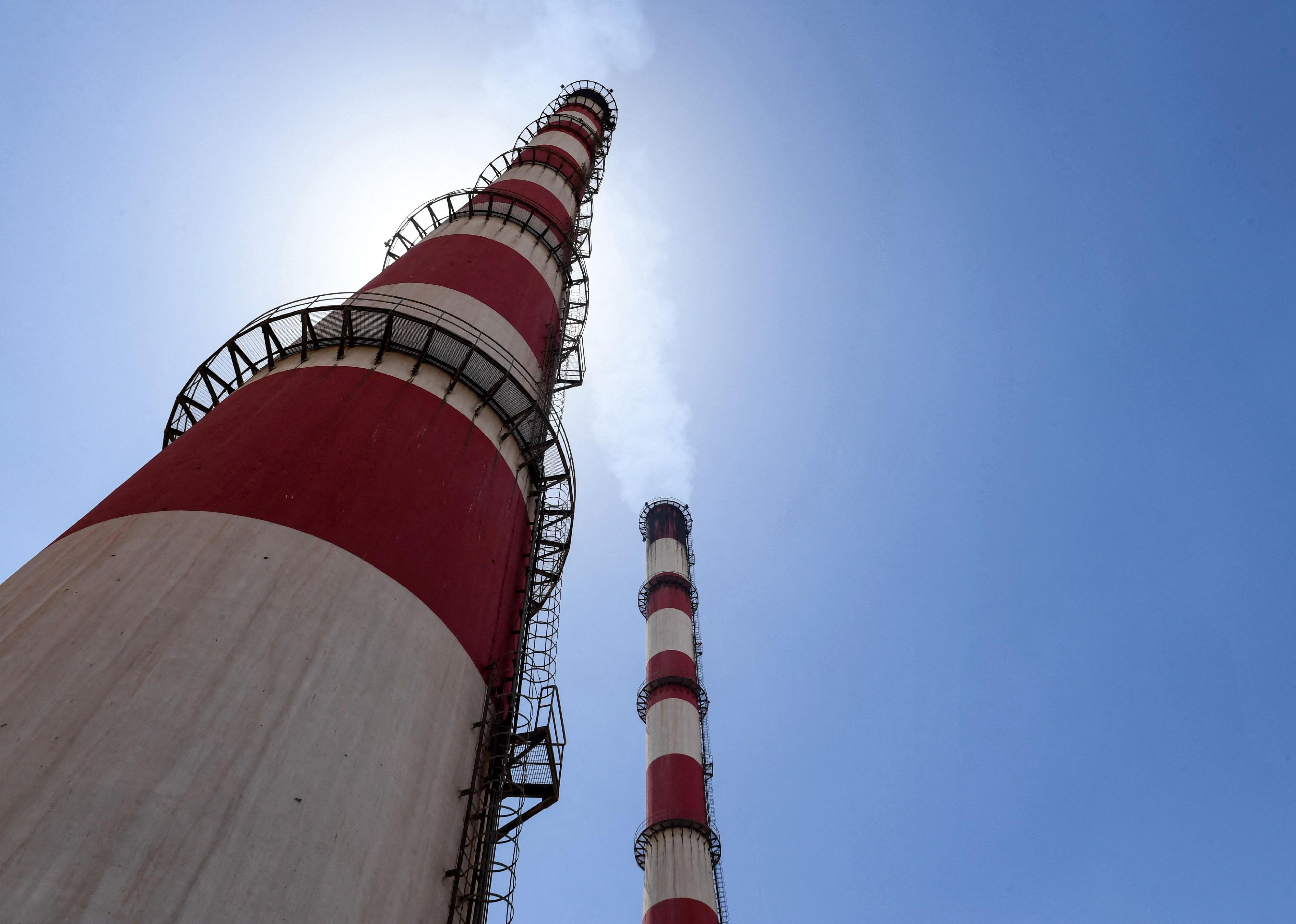 Red-and-white striped chimneys at the thermal natural gas and fuel-oil power plant serving Syria's northern city of Aleppo.