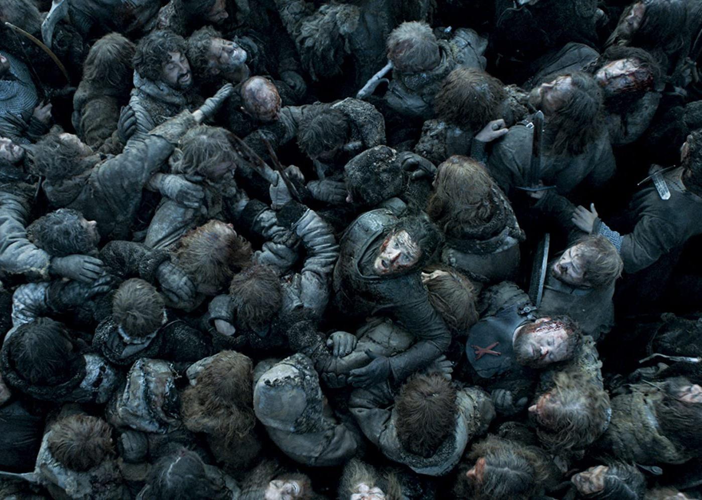 Kit Harington, in a sea of people in battle, looking up.