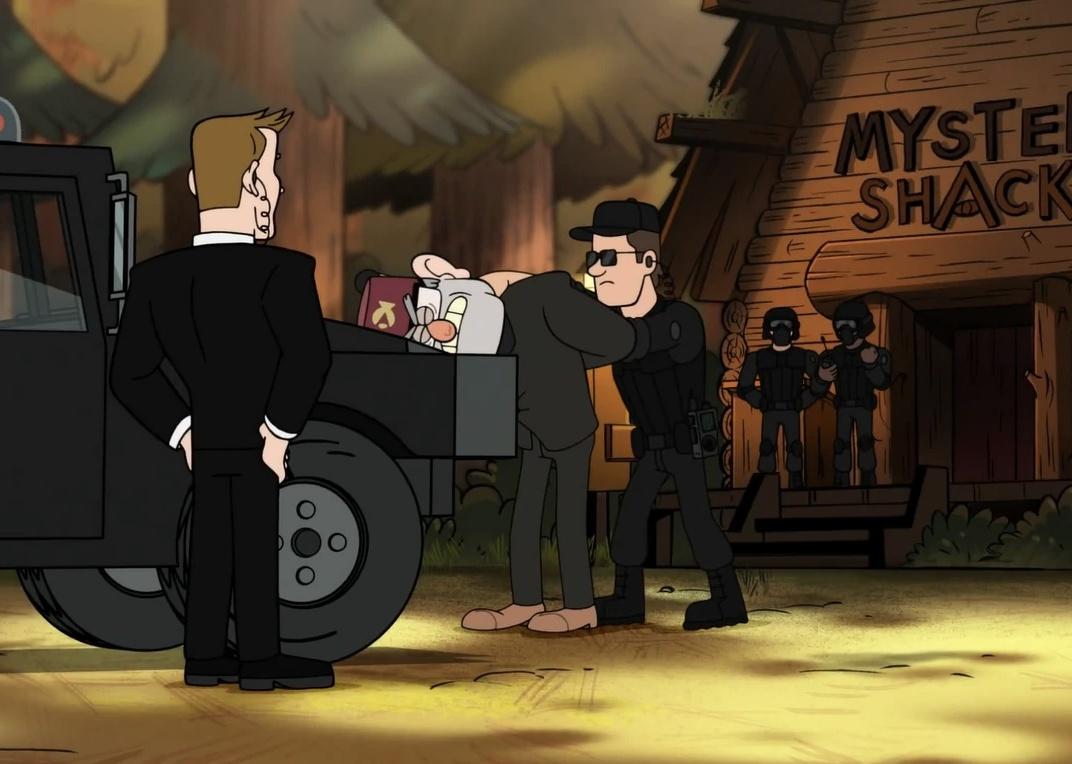 A man getting arrested outside of a mystery shack by men dressed in all black.
