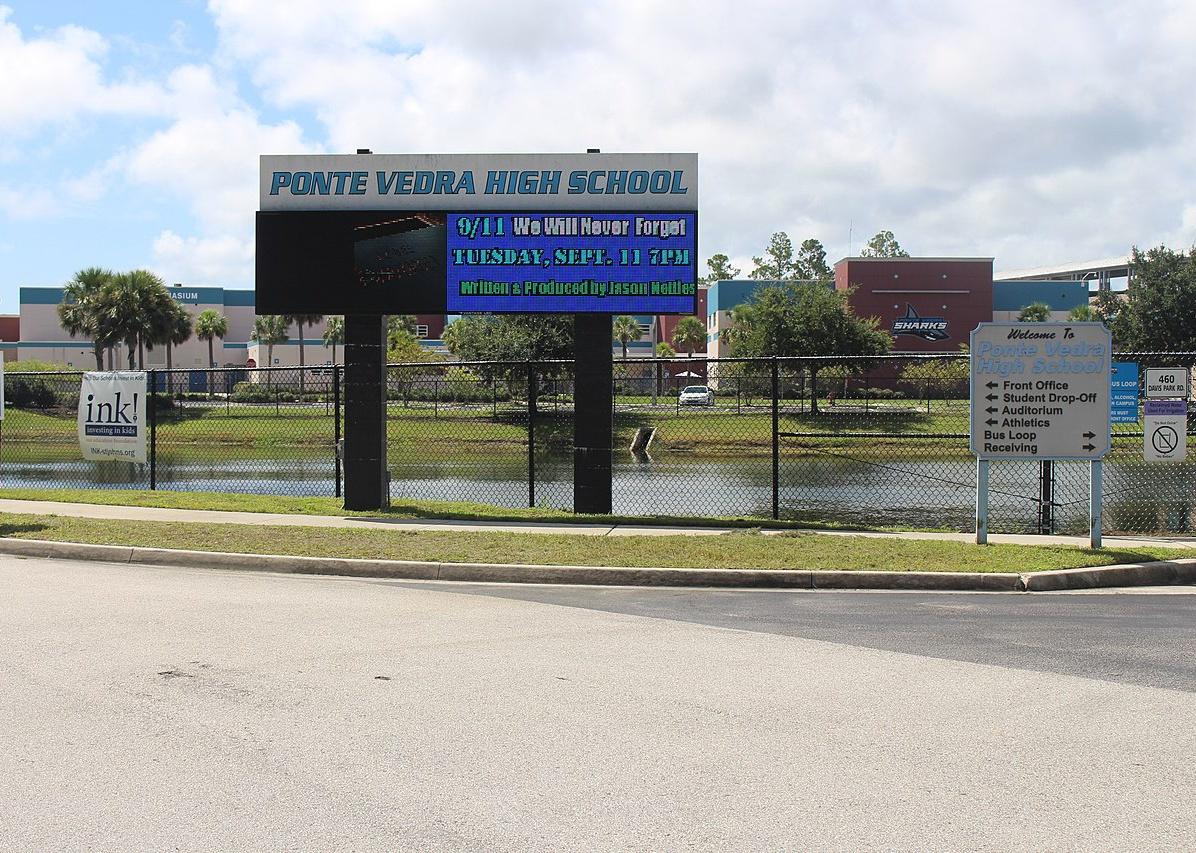 A high school with a pond in front.