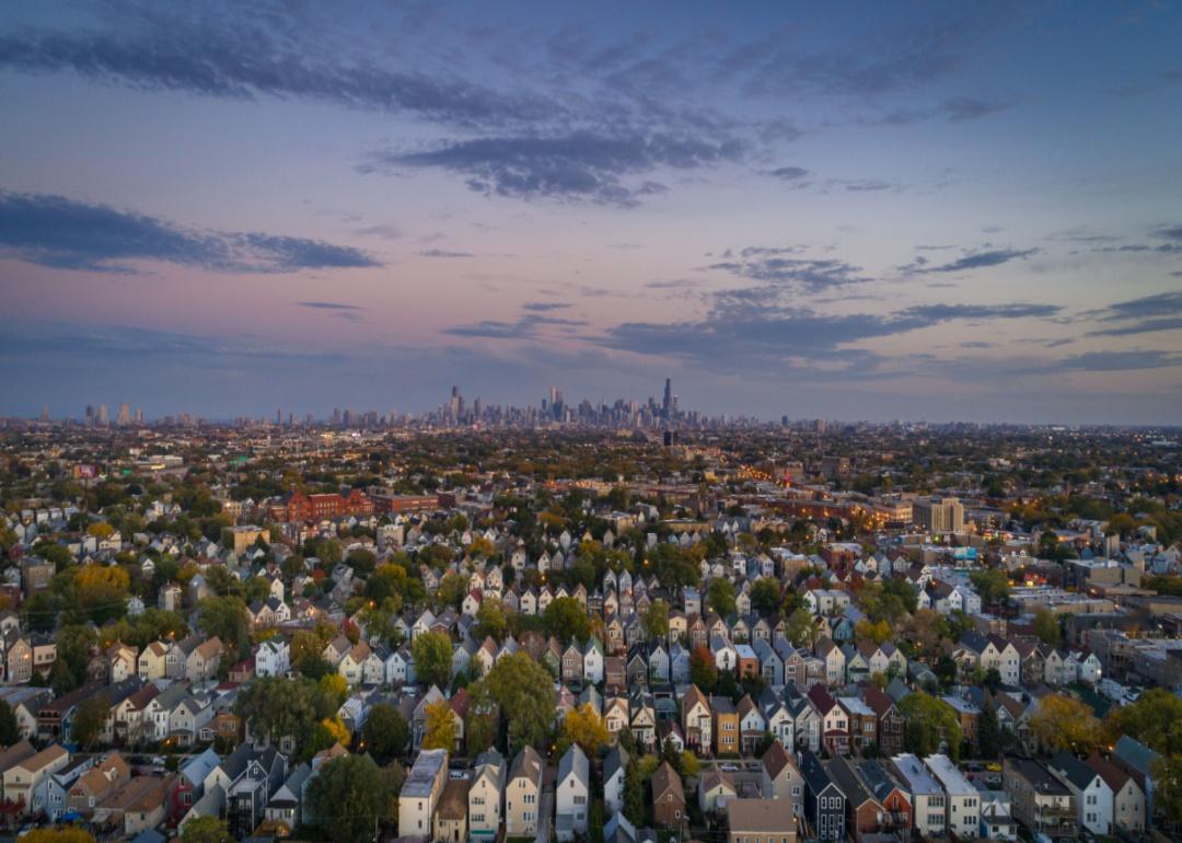 Dense rows of homes with the Chicago skyline in the distance.
