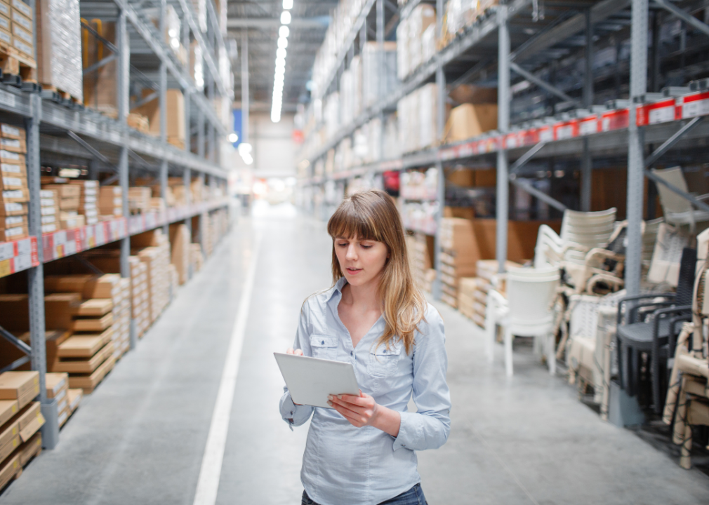 A woman working in a furniture warehouse.