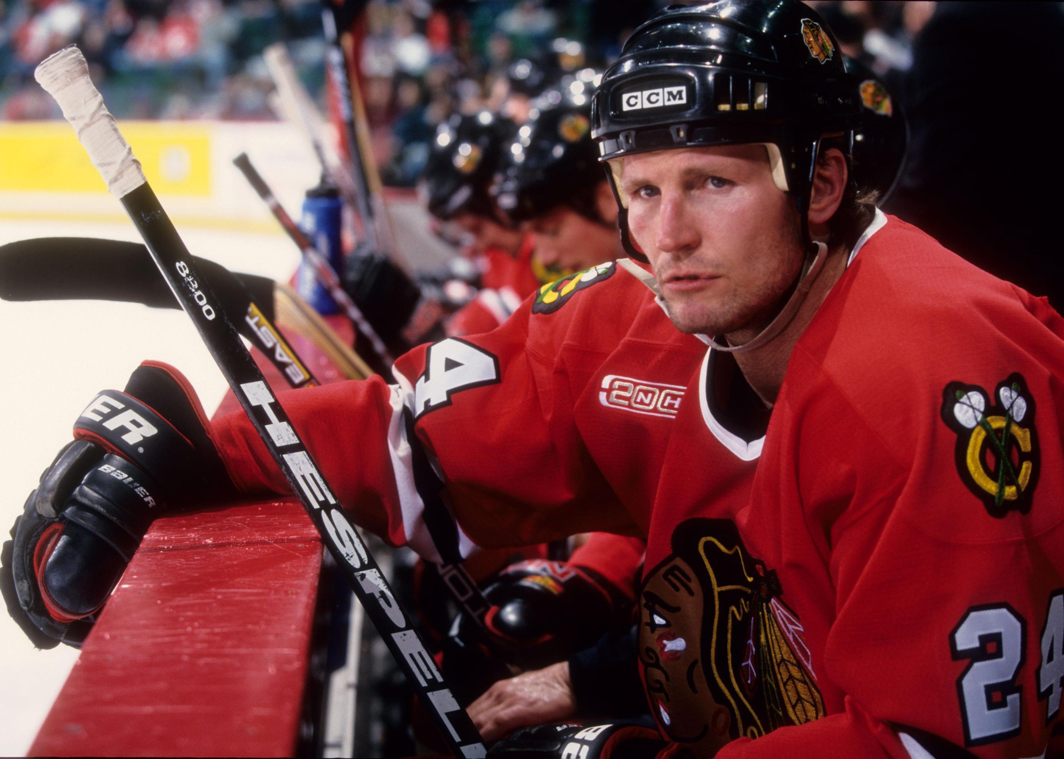 Bob Probert sits on the bench during an NHL game.
