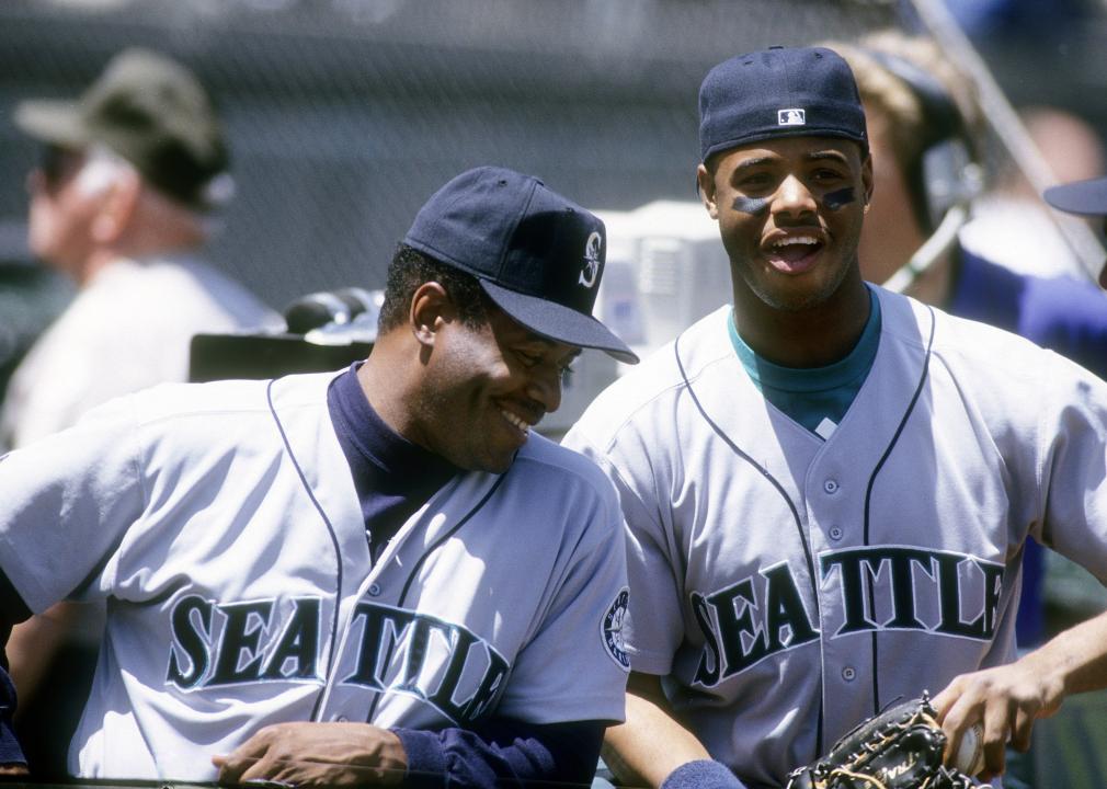 Ken Griffey Jr. and Ken Griffey Sr. of the Seattle Mariners laugh together, circa 1993.