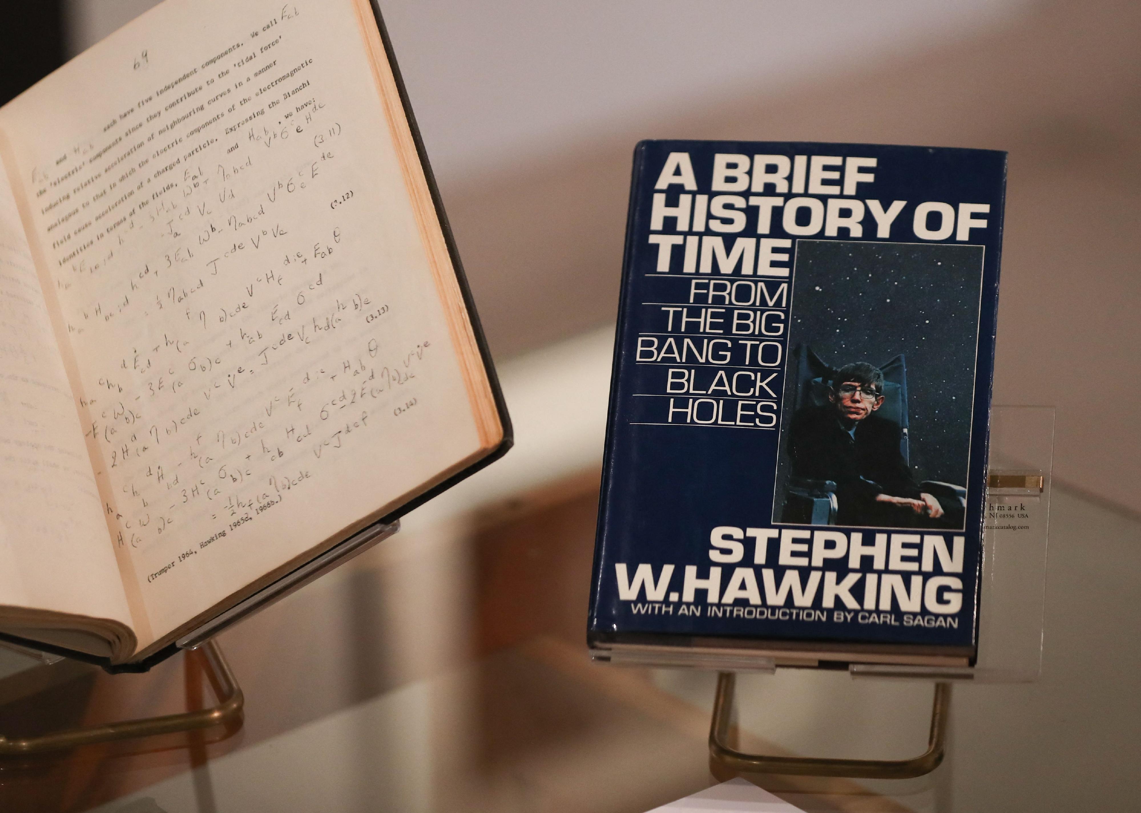 A picture shows the book 'A Brief History of Time' by theoretical physicist Stephen Hawking signed with a thumbprint.