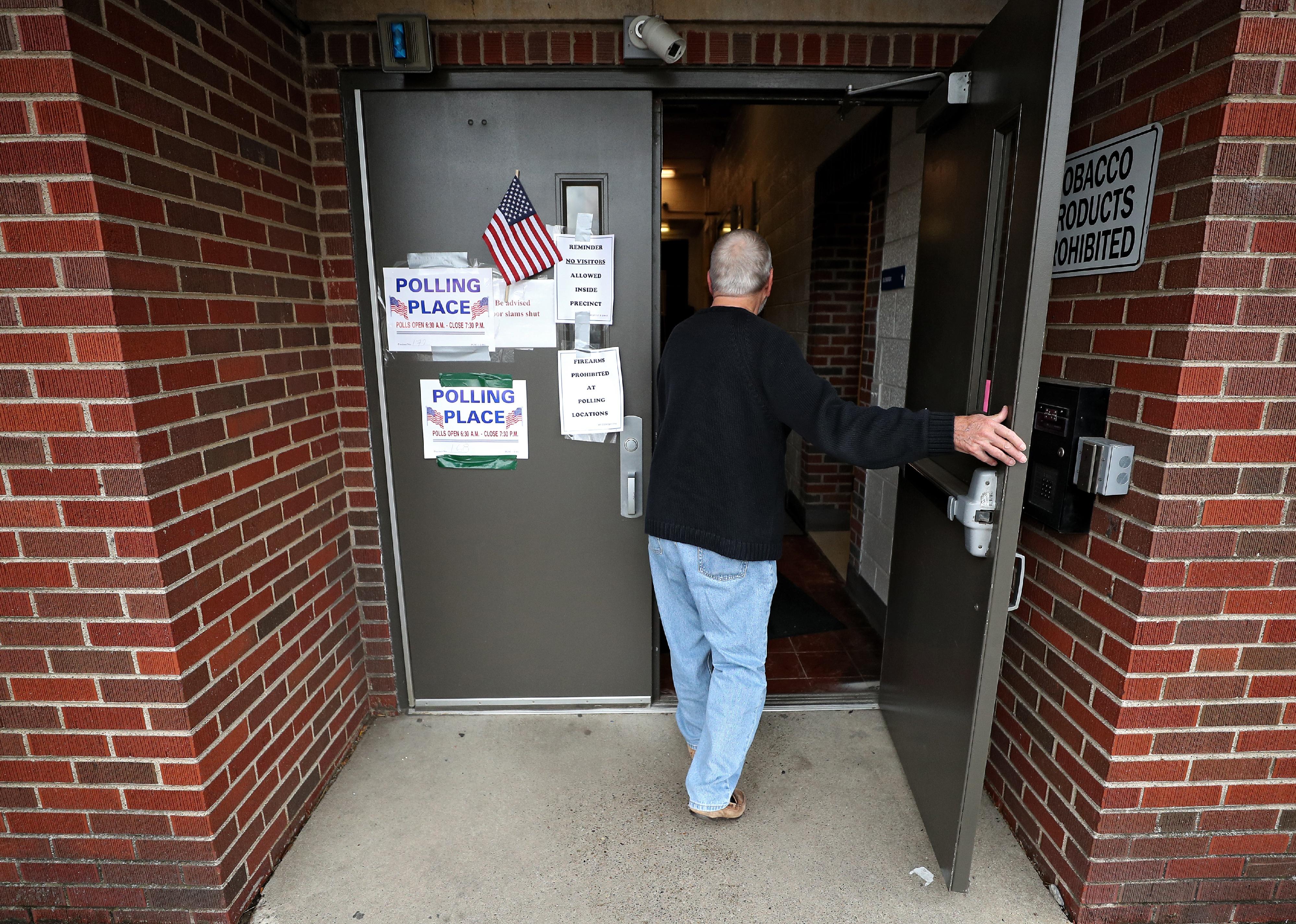 A voter walks into a polling station